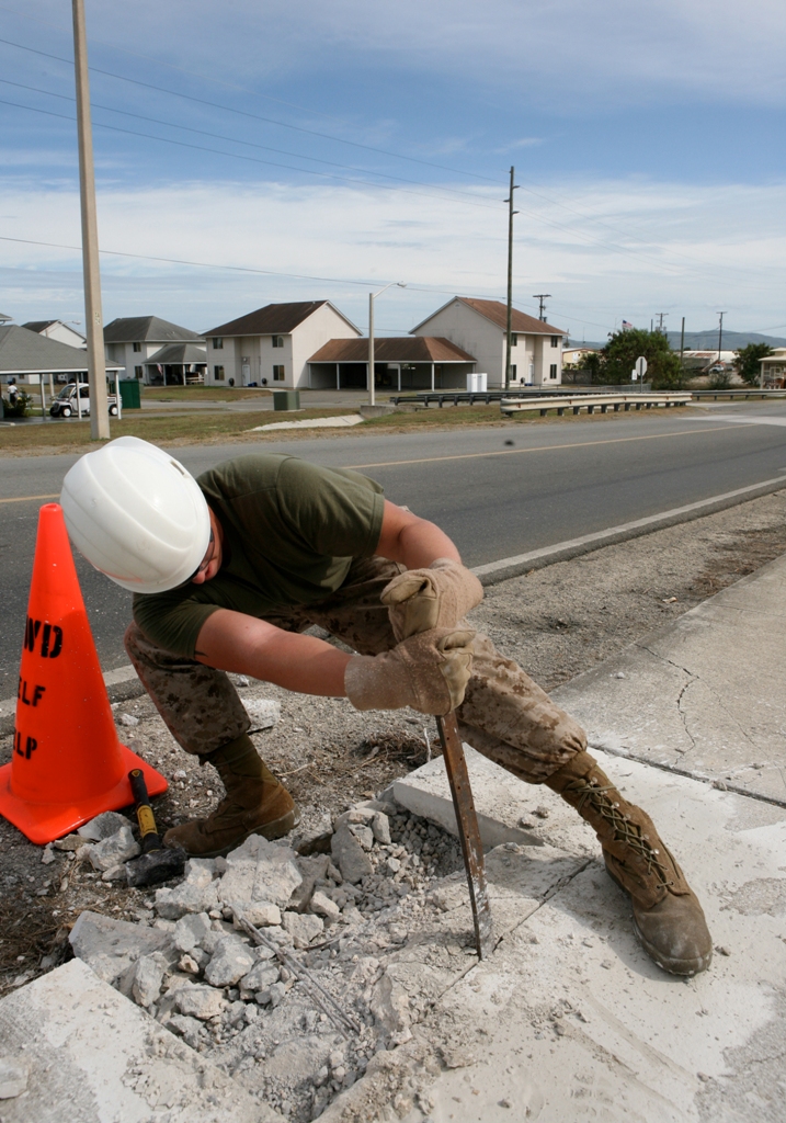 Lance Cpl. Charles F. Hammond, an electrician with the Security Cooperation Marine Air-Ground Task Force (SCMAGTF) Logistics Command Element, breaks loose damaged concrete as part of a public works project aboard Guantanamo Bay, Cuba Oct. 19. The SCMAGTF is currently deployed on Southern Partnership Station-Amphib with Destroyer Squadron 40 aboard USS Wasp (LHD 1). Southern Partnership Station is part of the Partnership of the Americas Maritime Strategy that focuses on building interoperability and cooperation in the region to meet common challenges. (U.S. Marine Corps photo by Sgt. Heather Brewer/Released)