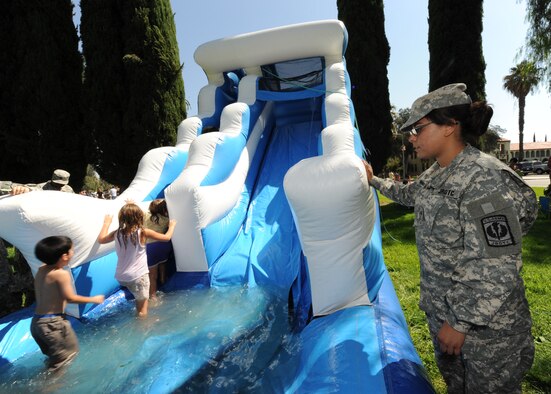 U.S. Army ROTC Cadet 2nd Lt. Dominque Alvarez, monitors children of military families as they play on an inflatable waterslide during the annual picnic at March ARB. (U.S. Air Force photo taken by Staff Sgt. Erica J. Knight)