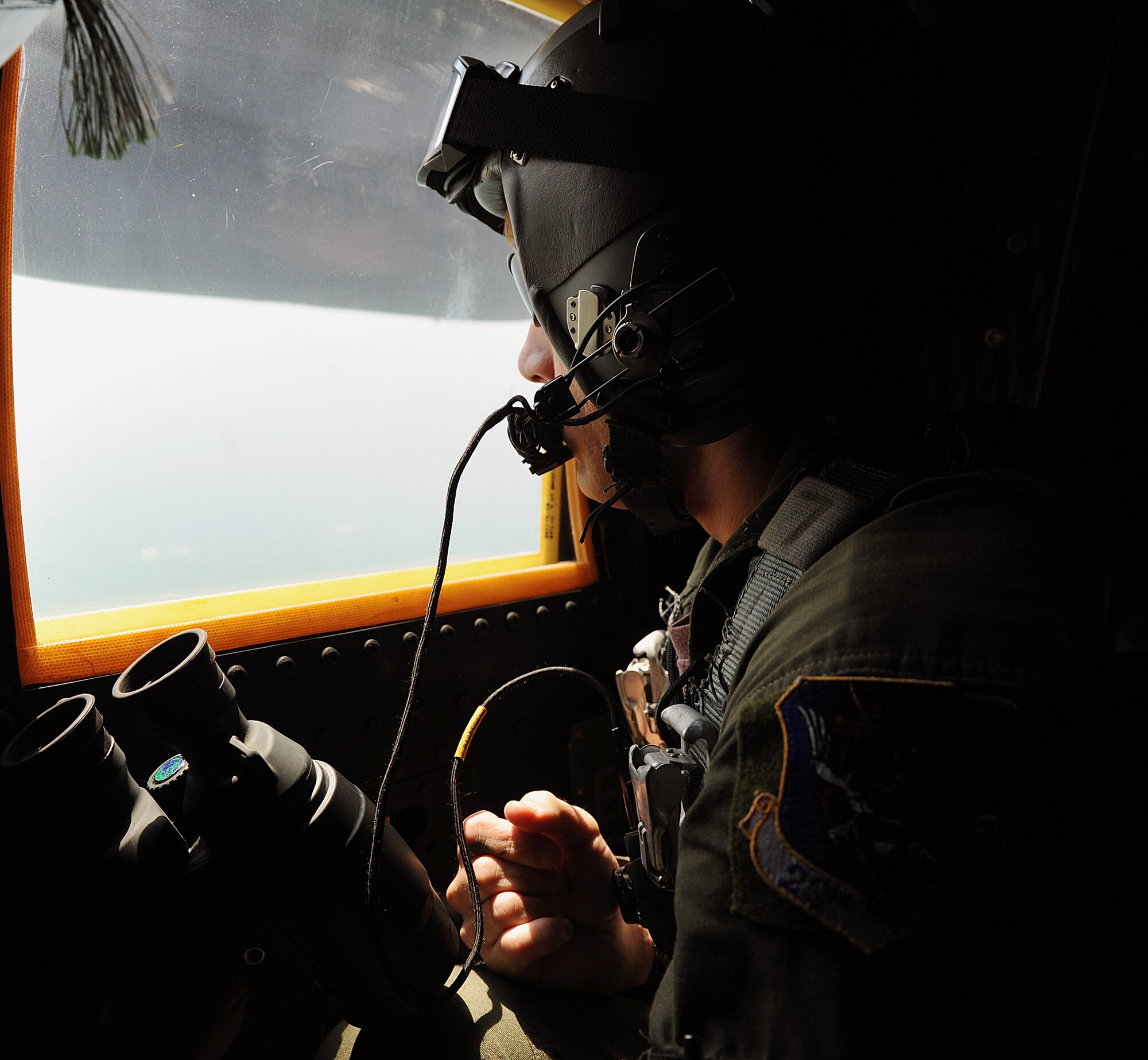 MOODY AIR FORCE BASE, Ga. -- Senior Airman Jared Delong, 723rd Aircraft Maintenance Squadron loadmaster, scans the Atlantic Ocean in an effort to find the missing F-16 Fighting Falcon pilot Oct. 17. from Shaw Air Force Base, S.C. (U.S. Air Force photo by Airman 1st Class Joshua Green)