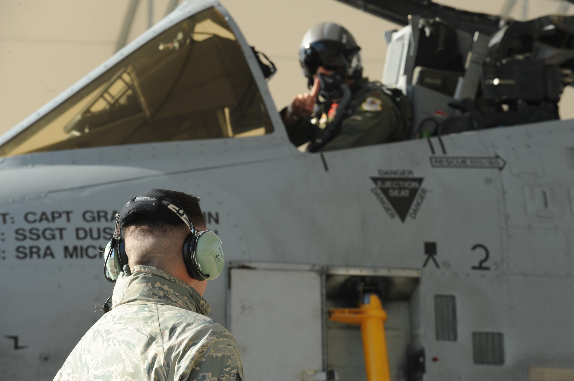 MOODY AIR FORCE BASE, Ga. -- Prior to a launch to Red Flag at Nellis Air Force Base, Nev., Senior Airman Brian Moran, 75th Aircraft Maintenance Unit A-10C Thunderbolt II assistant dedicated crew chief, communicates with Maj. John Lesho, 76th Fighter Squadron A-10C pilot, here Oct. 17. (U.S. Air Force photo by Staff Sgt. Elizabeth Rissmiller)