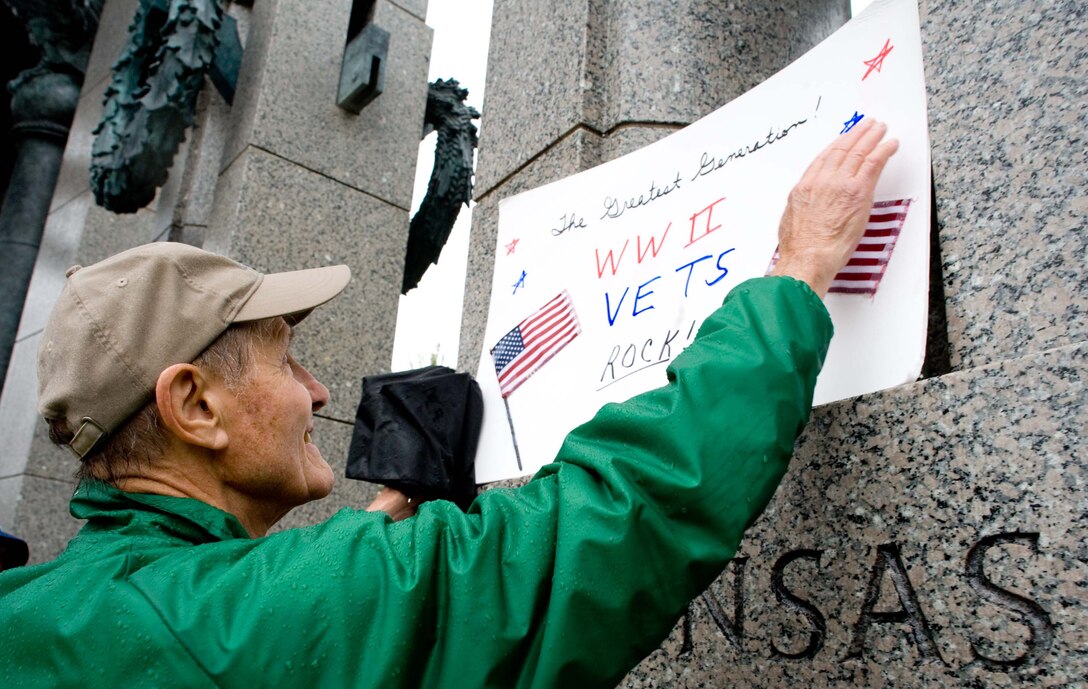 LANGLEY AIR FORCE BASE, Va. – Kent Roberts, a World War II veteran, displays a poster at the National World War II Memorial in Washington, D.C., Oct. 17.  Twice a year, the Honor Flight Historic Triangle Virginia, and Langley volunteers, chauffeur veterans to the WW II memorial in Washington, D.C.  (U.S. Air Force photo/Staff Sgt. Barry Loo)
