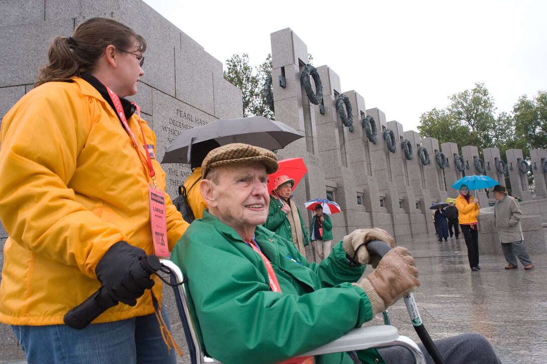 LANGLEY AIR FORCE BASE, Va. – Tom Hughes, a World War II veteran, tours the National World War II Memorial with the help of Tech. Sgt. Lorrie McCarty, 735th Supply Chain Management Group division training non-commissioned officer-in-charge, in Washington, D.C., Oct. 17.  Twice a year, the Honor Flight Historic Triangle Virginia, and Langley volunteers, chauffeur veterans to the WW II memorial in Washington, D.C.  (U.S. Air Force photo/Staff Sgt. Barry Loo)
