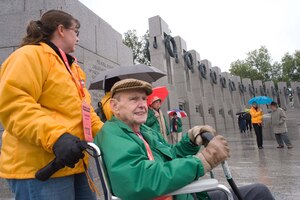 LANGLEY AIR FORCE BASE, Va. – Tom Hughes, a World War II veteran, tours the National World War II Memorial with the help of Tech. Sgt. Lorrie McCarty, 735th Supply Chain Management Group division training non-commissioned officer-in-charge, in Washington, D.C., Oct. 17.  Twice a year, the Honor Flight Historic Triangle Virginia, and Langley volunteers, chauffeur veterans to the WW II memorial in Washington, D.C.  (U.S. Air Force photo/Staff Sgt. Barry Loo)