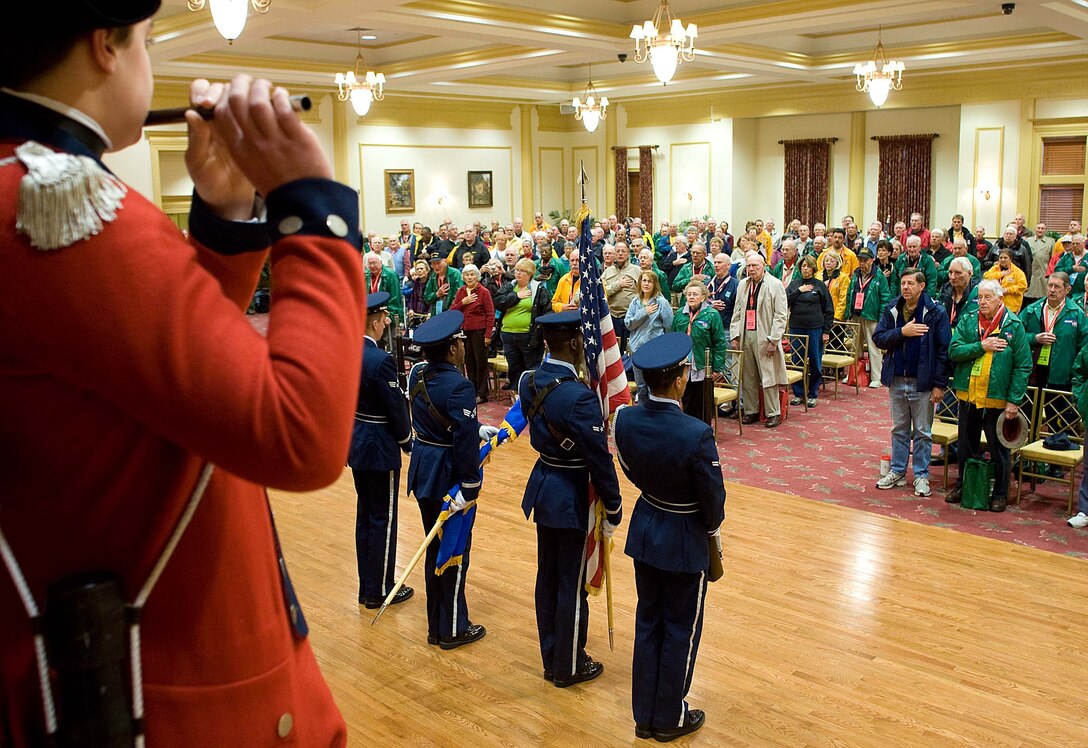 LANGLEY AIR FORCE BASE, Va. – World War II veterans stand while Langley Honor Guard presents the colors and Colonial Williamsburg Fifes and Drums band performs the national anthem at the Colonial Heritage Club House in Williamsburg, Va., Oct. 17.  Twice a year, the Honor Flight Historic Triangle Virginia, and Langley volunteers, chauffeur veterans to the WW II memorial in Washington, D.C.  (U.S. Air Force photo/Staff Sgt. Barry Loo)