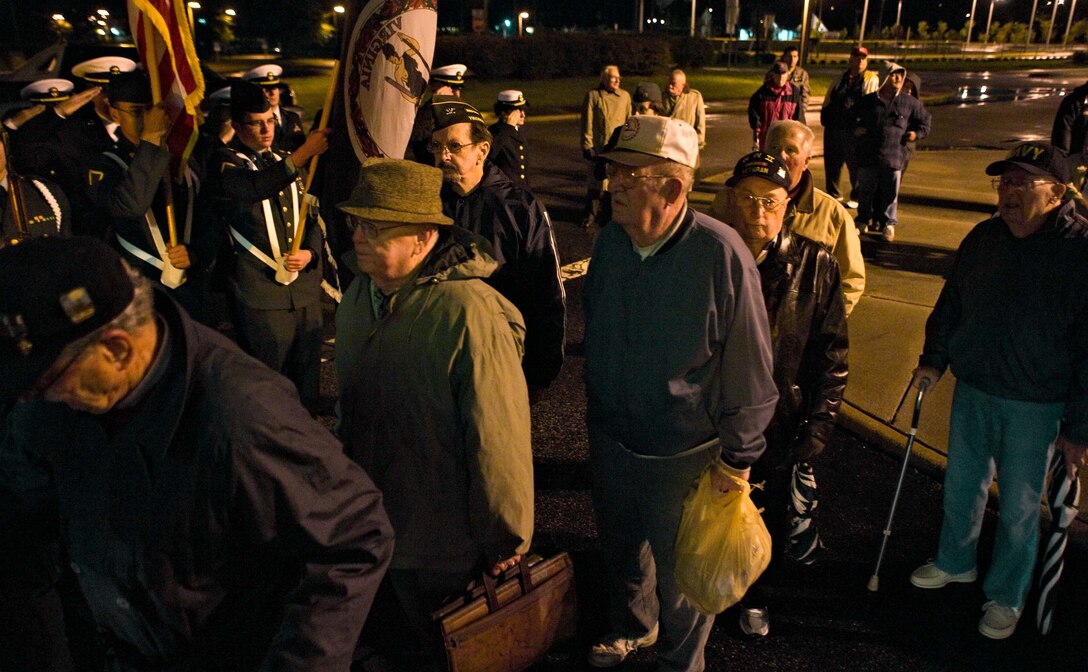 LANGLEY AIR FORCE BASE, Va. – World War II veterans board a bus to Washington, D.C., while members of Old Dominion University Reserve Officer Training Corps render honors to them in Norfolk, Va., Oct. 17.  Twice a year, the Honor Flight Historic Triangle Virginia, and Langley volunteers, chauffeur veterans to the WW II memorial in Washington, D.C.  (U.S. Air Force photo/Staff Sgt. Barry Loo)