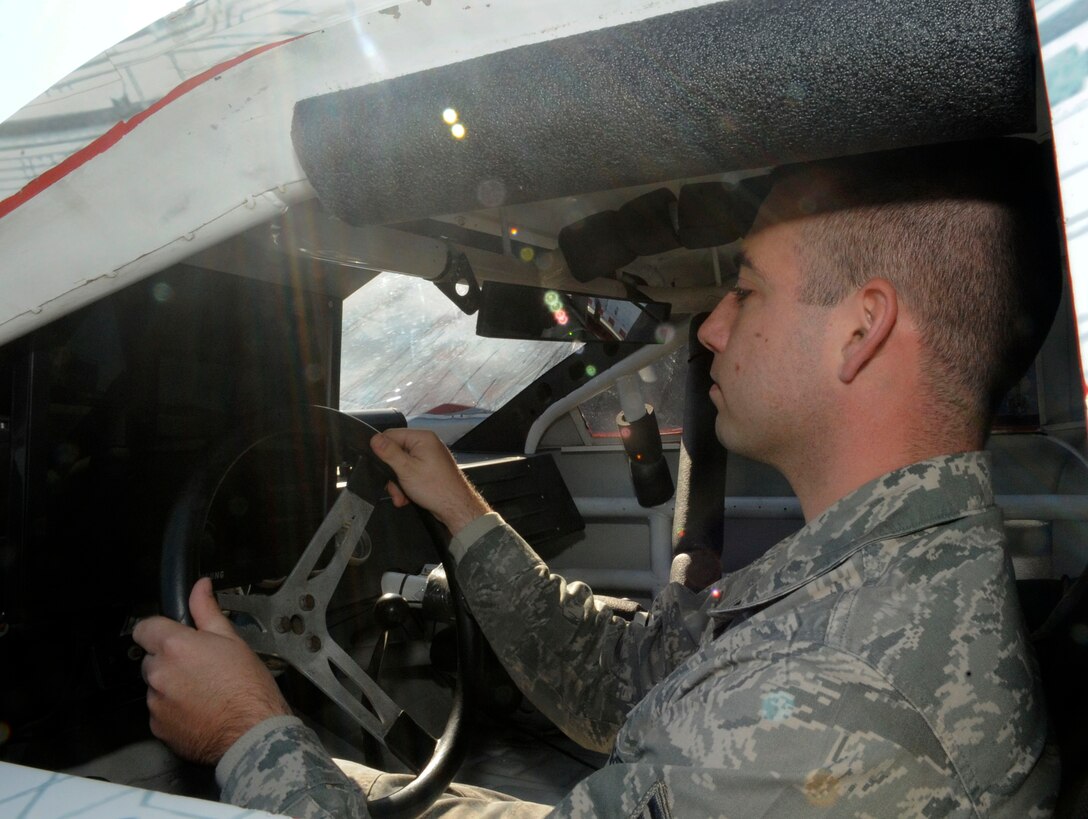 LANGLEY AIR FORCE BAE, Va. -- Senior Airman Samuel Glenn, 1st Communications Squadron information technology manager, operates a full-sized virtual NASCAR racing simulator here Oct. 19. This event kicked-off Langley’s Red Ribbon Month, a campaign which heightens awareness of destructive effects of drug use and positive alternatives available. (U.S. Air Force photo/Senior Airman Dana Hill) 