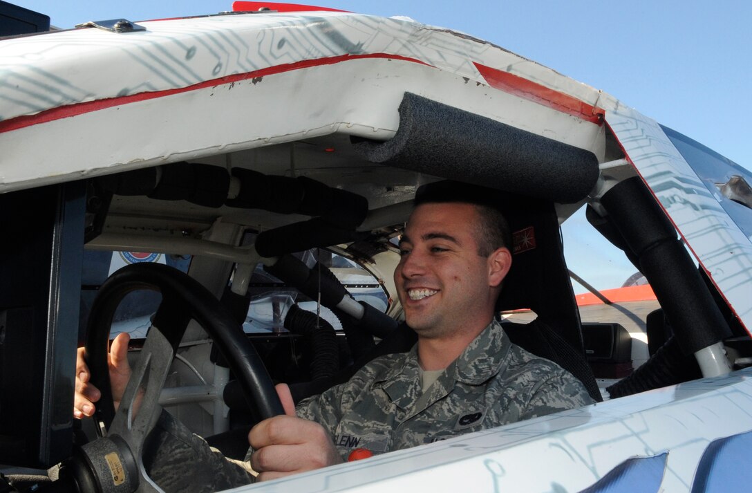 LANGLEY AIR FORCE BAE, Va. -- Senior Airman Samuel Glenn, 1st Communications Squadron information technology manager, operates a full-sized virtual NASCAR racing simulator here Oct. 19. This event kicked-off Langley’s Red Ribbon Month, a campaign which heightens awareness of destructive effects of drug use and positive alternatives available. (U.S. Air Force photo/Senior Airman Dana Hill) 