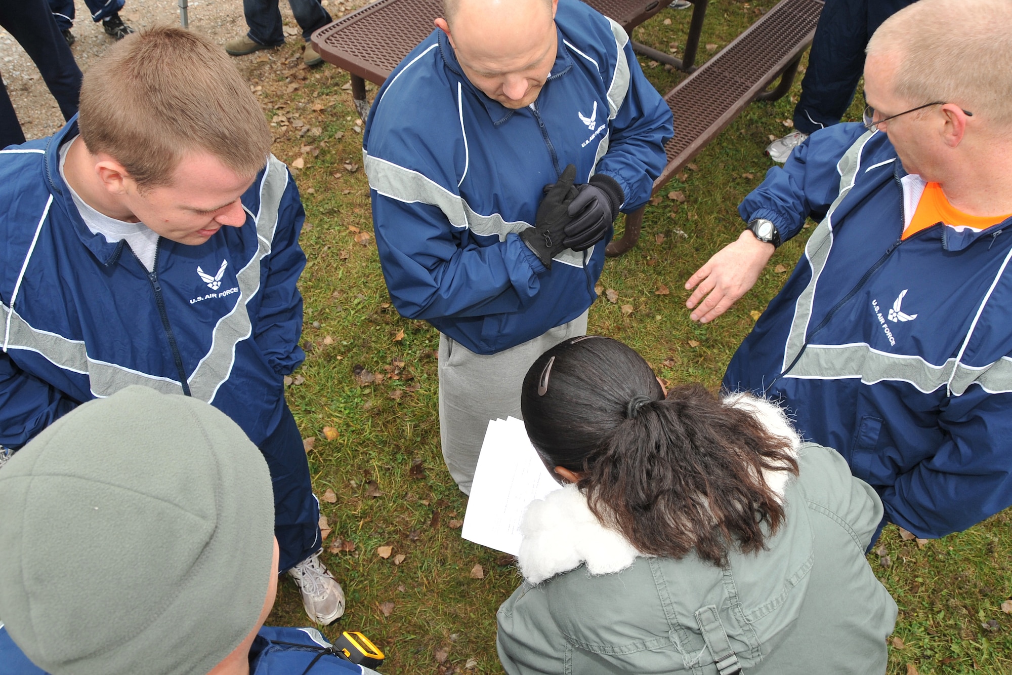 OFFUTT AIR FORCE BASE, Neb. - The 55th Operations Support Squadron team are given clues to follow as part of the geo trekking exercise during Offutt Wingman Day Oct. 16. During the exercise, teams made up of six members used electronic devices to locate hidden boxes throughout the base lake area.  Geo trekking was just one of several events for Airmen to take part in during the day designed to promote teamwork. 

U.S. Air Force Photo by Jeff W. Gates.