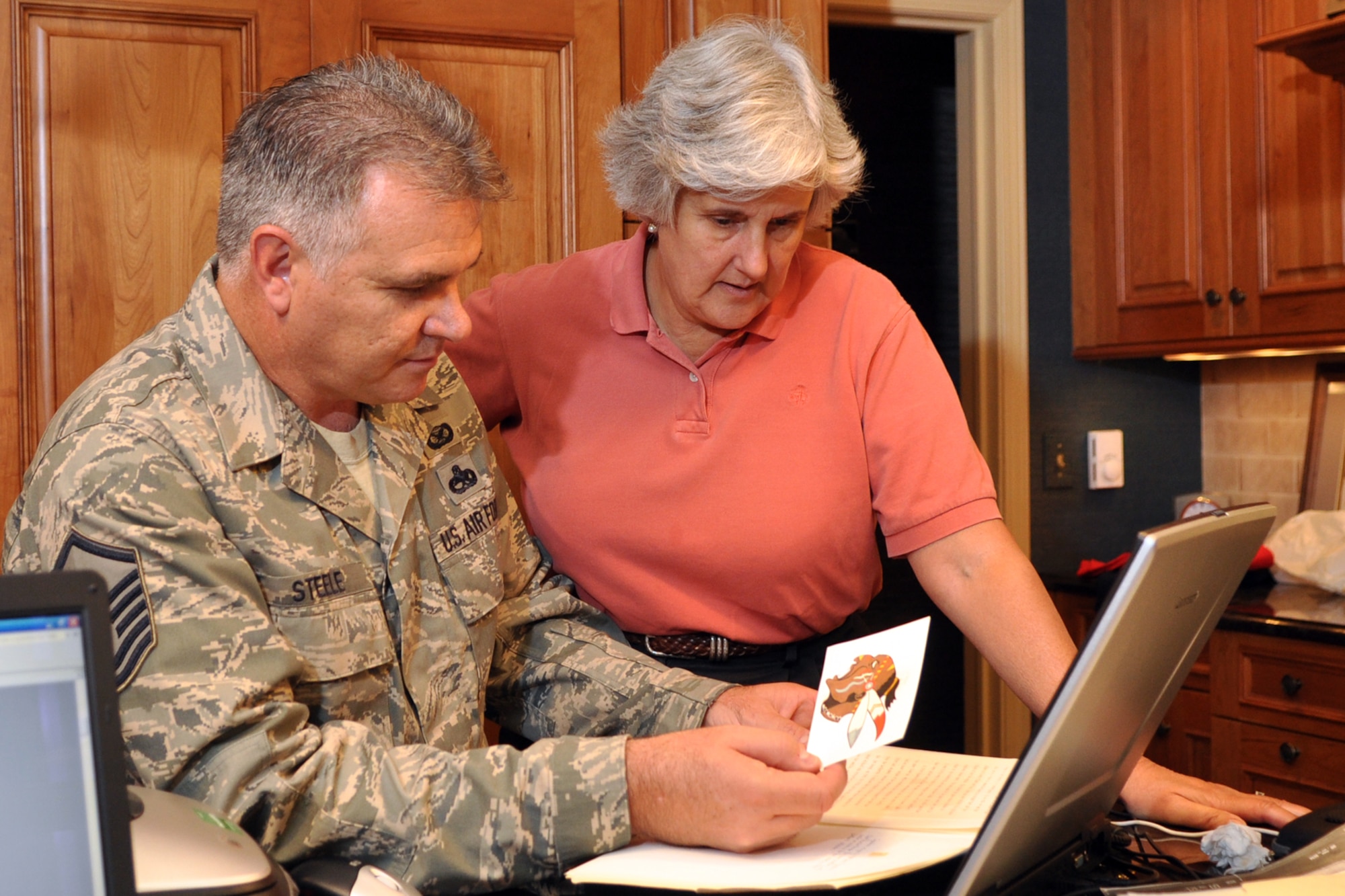 Master Sgt. Greg Steele, 47th Fighter Squadron, visual information specialist, and Susan d’Olive Mozena, daughter of 1st Lt. Charles R. D’Olive, a WWI Ace, read the account of how the “Indian Head” design for the 93rd Bomb Squadron was originally conceived, October, 10, 2009. Sergeant Steele traveled to Detroit, Mich., to gather photos and documents from Mrs. d’Olive Mozena concerning her father’s role in the history of the 93rd BS, which is part of the 917th Wing at Barksdale Air Force Base, La. The items will be used in historic displays at the 917th Wing headquarters building in the future. (U.S. Air Force photo/Tech. Sgt. Jeff Walston)