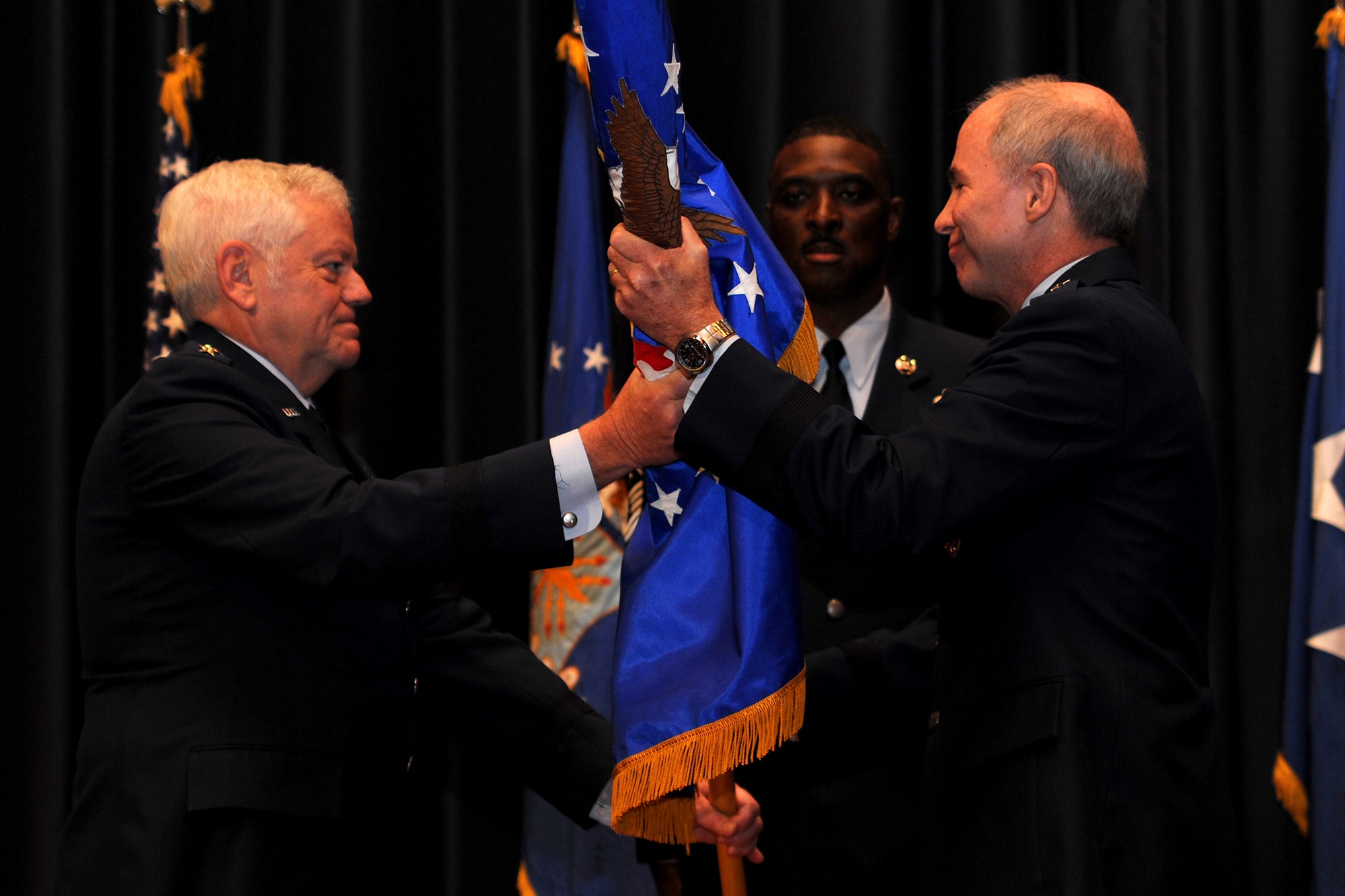 Gen. Arthur Lichte, Air Mobility Command commander, presents the United States Air Force Expeditionary Center flag to Brig. Gen. Richard Devereaux Oct. 19 during a change of command ceremony at Joint Base McGuire-Dix-Lakehurst, N.J.  Maj. Gen. Kip Self relinquished command of the Expeditionary Center.  (U.S. Air Force Photo/Staff Sgt. Nathan G. Bevier) 