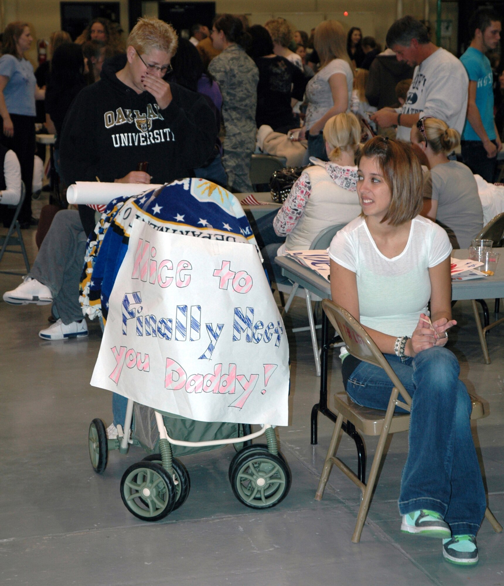 Jill Allera waits  in building 1460 with 27-day-old Victoria Oct. 11 for her husband, Senior Airman Joseph Allero. Airman Allera is a member of the 819th RED HORSE Squadron returning to Malmstrom following a six month deployment in support of operations in Iraq and Afghanistan. (U.S. Air Force photo/Senior Airman Dillon White)