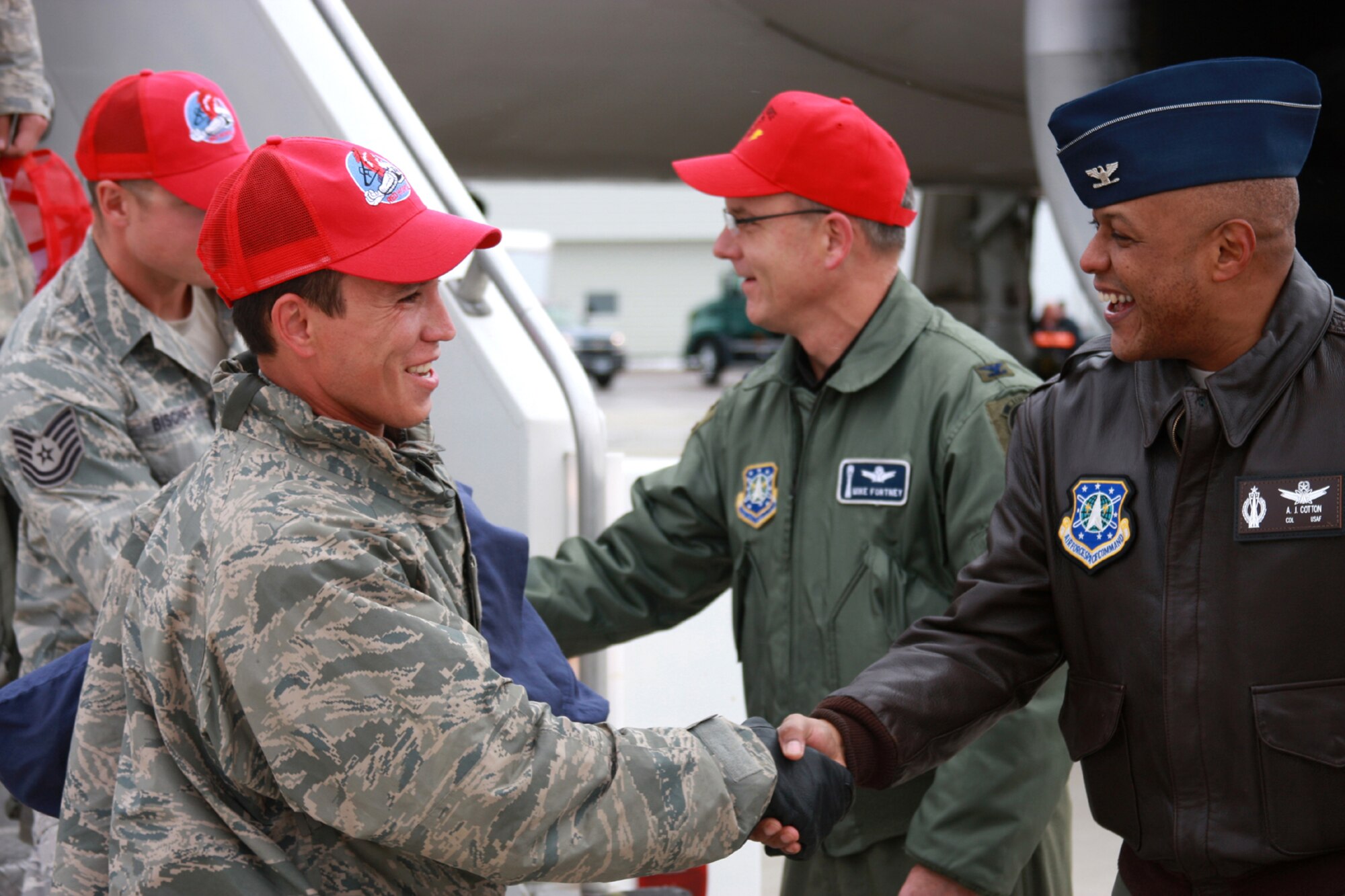 Col. Michael Fortney, 341st Missile Wing commander, and Col.  Anthony Cotton, 341 MW vice commander, right, welcomes home Airman 1st Class Ryan Dickinson and other members of the 819th RED HORSE Squadron upon their arrival at Holman Aviation Oct. 11. Nearly 250 Malmstrom Airmen returned to Montana following a six-month deployment in support of operations in Iraq and Afghanistan. (U.S. Air Force photo/Tech. Sgt. Marcus McDonald)