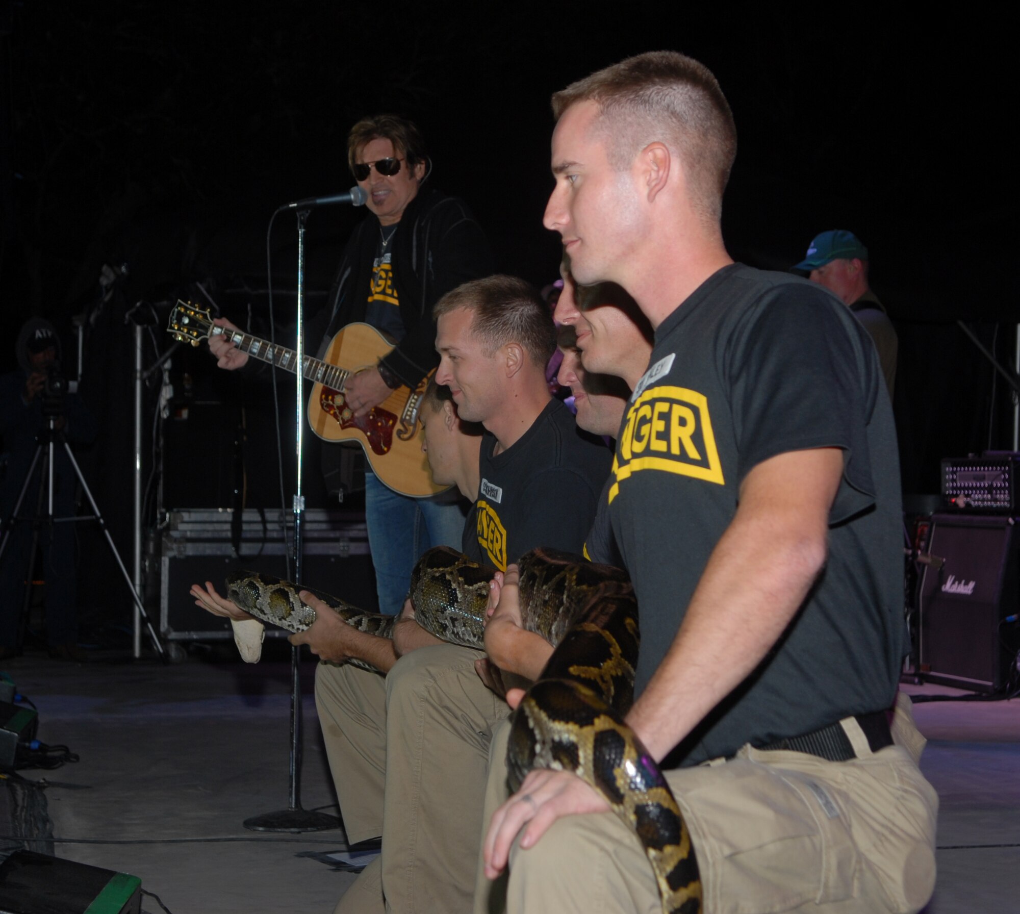 Niceville, Fla. -- Rangers from the 6th Ranger Training Battalion join Billy Ray Cyrus on stage during the Boggy Bayou Mullet Festival Oct. 18.  The Rangers have staffed a tent at the festival that displays reptiles for the past 20 years.  (Courtesy photo)
