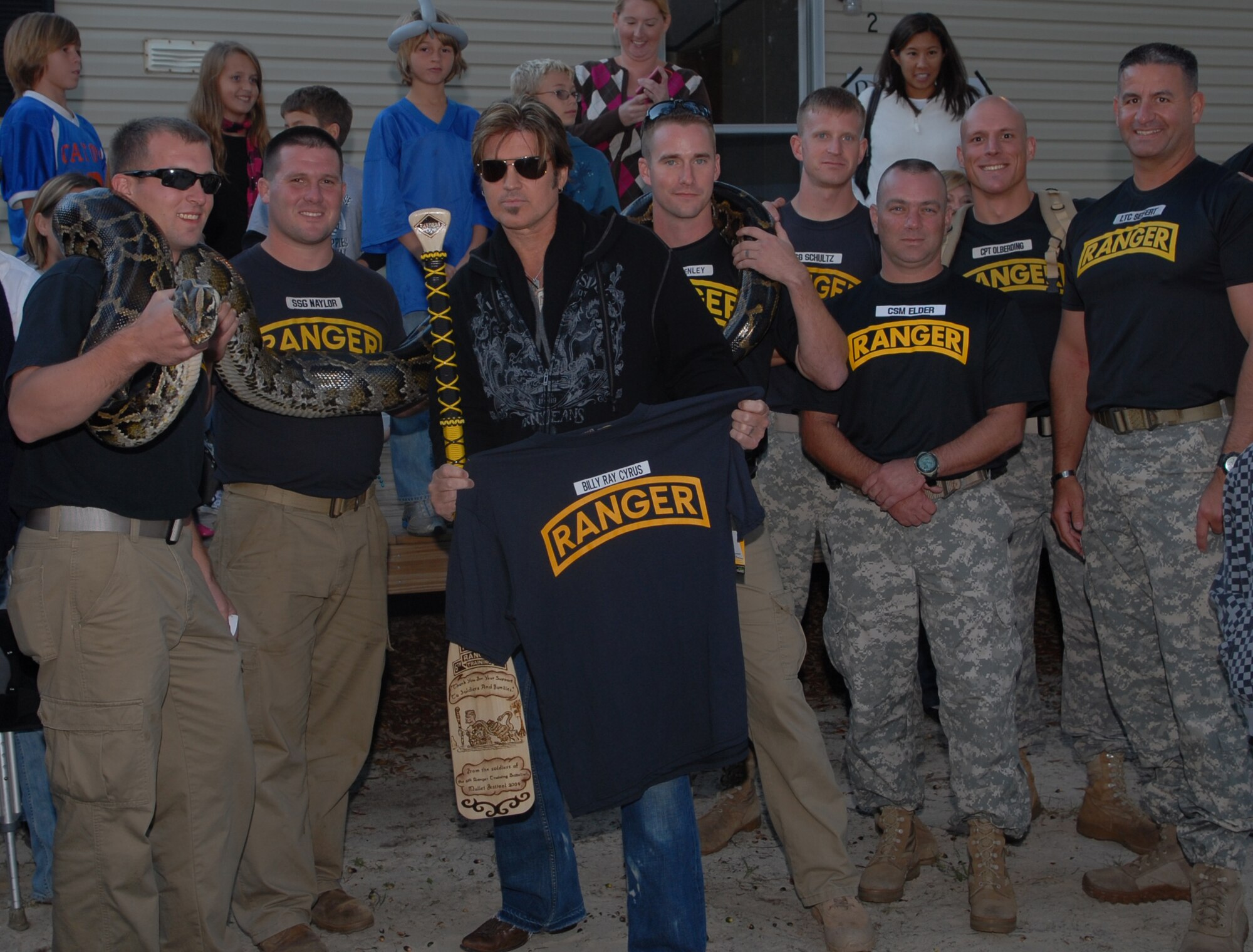 Niceville, Fla. -- Rangers from the 6th Ranger Training Battalion join Billy Ray Cyrus on stage during the Boggy Bayou Mullet Festival Oct. 18.  The Rangers have staffed a tent at the festival that displays reptiles for the past 20 years.  (Courtesy photo)