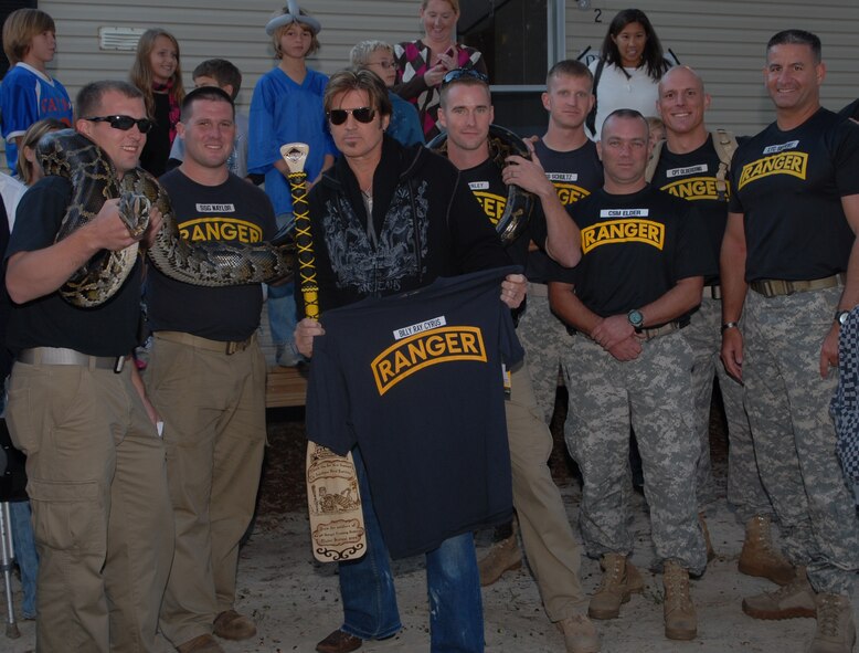 Niceville, Fla. -- Rangers from the 6th Ranger Training Battalion join Billy Ray Cyrus on stage during the Boggy Bayou Mullet Festival Oct. 18.  The Rangers have staffed a tent at the festival that displays reptiles for the past 20 years.  (Courtesy photo)
