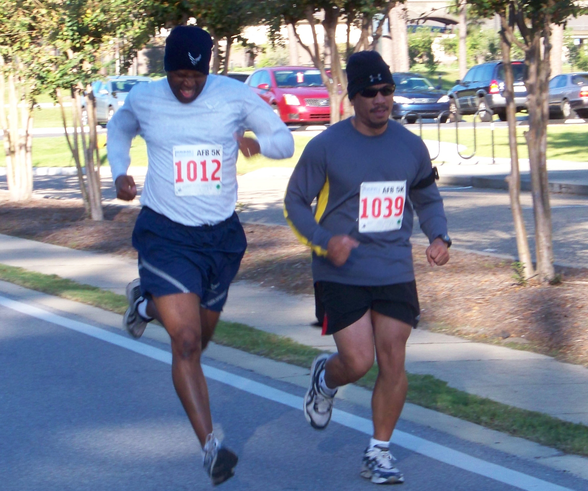 Maj. Lamont Coleman, 1st Special Operations Force Support Squadron Commander, and Reynaldo Dungca, 801st Aircraft Maintenance Squadron, run at the 5k Commando Run at the Aderholt Fitness Center at Hurlburt Field Oct. 17. (Air Force photo by Airman 1st Class Joe McFadden.)