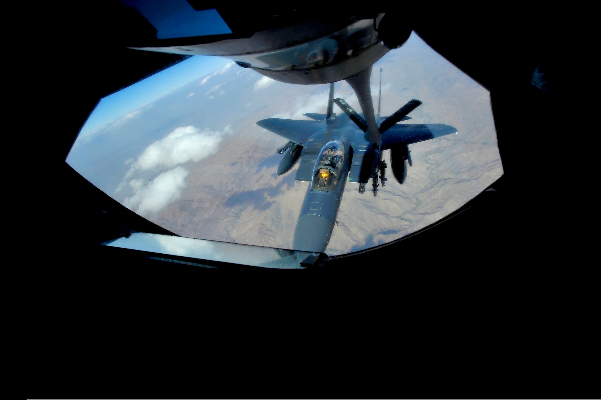 An F-15E Strike Eagle is refueled by a KC-135 Stratotanker Sept. 25, 2009, over Afghanistan. The KC-135 is one of Air Mobility Command's leading air refueling aircraft supporting deployed operations for both Operation Enduring Freedom and Operation Iraqi Freedom. (U.S. Air Force photo/Staff Sgt. Angelita Lawrence) 
