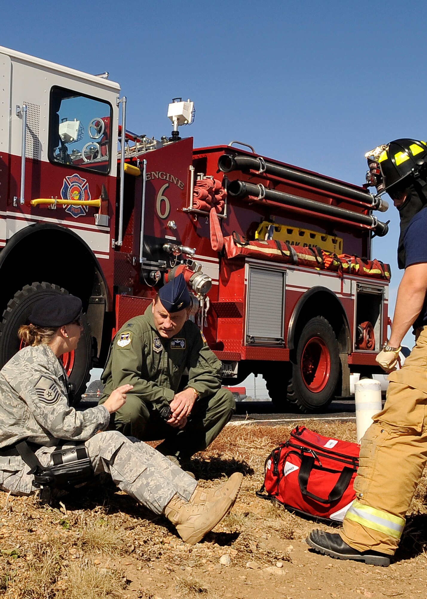 Buckley Air Force Base, Colo. -- Col. Clint Crosier, 460th Space Wing commander, speaks with Master Sgt. Adele Loar, 460th Security Forces Squadron, and Dennis Colgan, 460th Civil Engineer Squadron, during an exercise, Oct. 16. (U.S. Air Force photo by Staff Sgt. Steve Czyz)