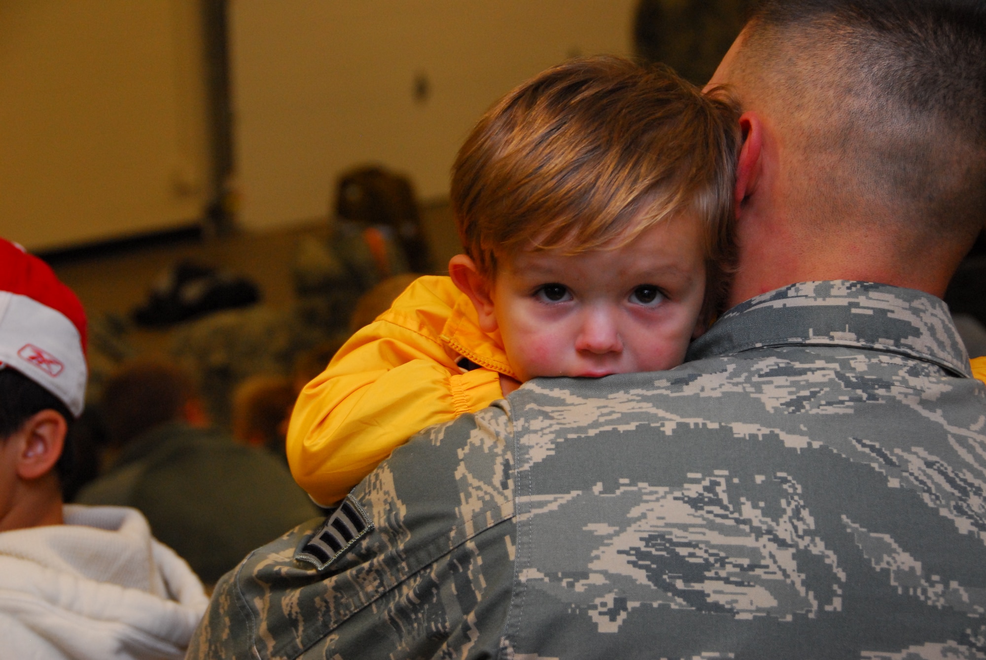 Air National Guardsman Staff. Sgt. Patrick Hakes says goodbye to his son as he prepares to deploy early Monday morning October 19th, 2009 at the Duluth, Minn. Air National Guard Base.  148th Fighter Wing Security Forces personnel are deploying to Southwest Asia in support of Operation Iraqi Freedom.