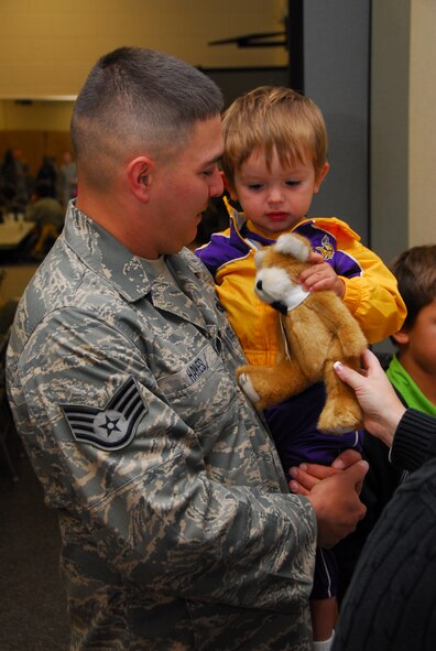 Air National Guardsman Staff. Sgt. Patrick Hakes says goodbye to his son as he prepares to deploy early Monday morning October 19th, 2009 at the Duluth, Minn. Air National Guard Base.  148th Fighter Wing Security Forces personnel are deploying to Southwest Asia in support of Operation Iraqi Freedom.