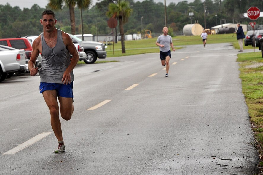 EGLIN AIR FORCE BASE, Fla. – Capt. Scott Griffith, Operational Flight Program Combined Test Force, sprints to the finish line during the Breast Cancer Awareness Month 5K Run, Oct. 16. The event was held to raise awareness of the importance for women to self-test and catch the disease in its early stages. More than 300 people participated in the event. Captain Griffith and Paula Piazza, 96th Medical Operations Squadron, were the first male and female to finish the run with a time of 15:58 and 18:54, respectively. (U.S. Air Force photo/ Airman Anthony Jennings)