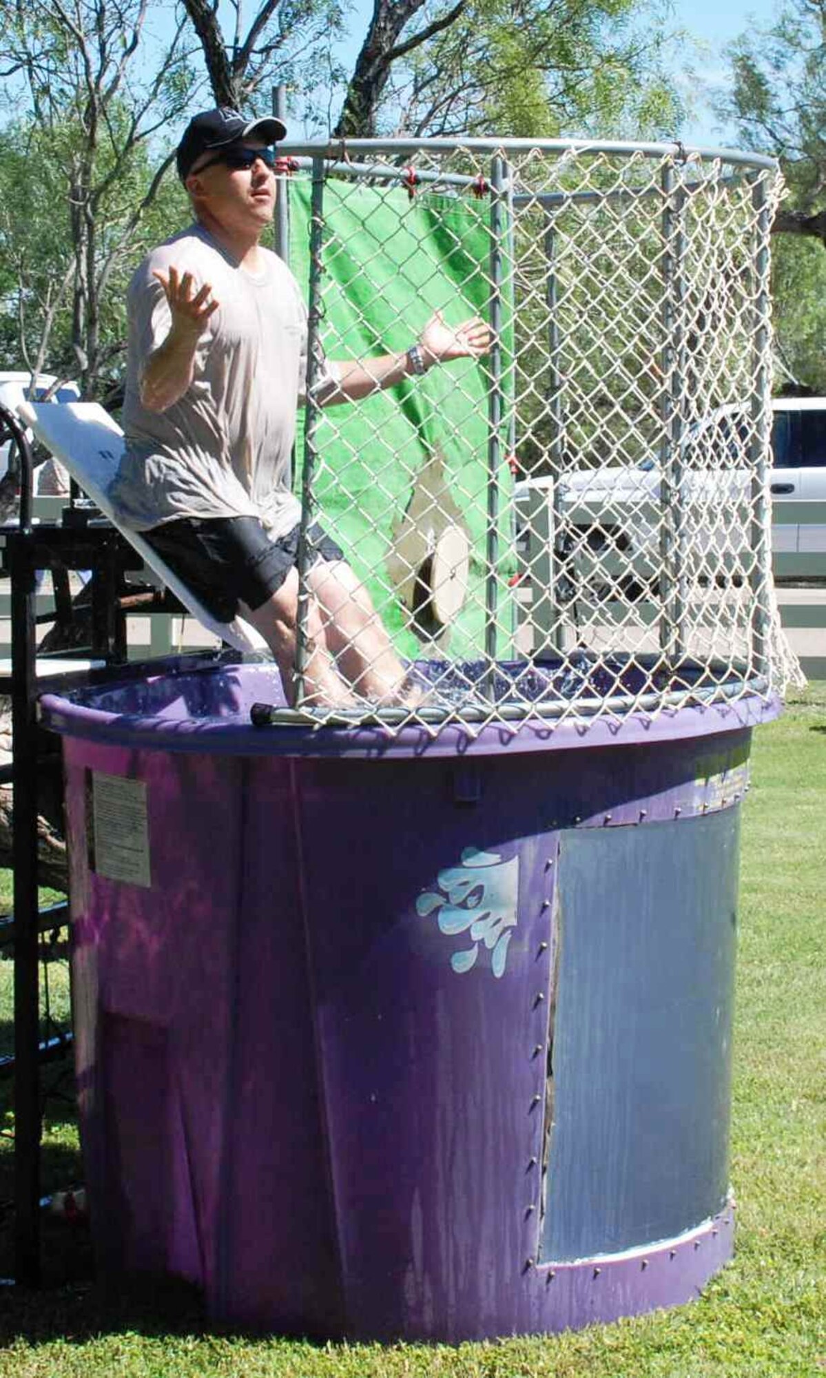 LAUGHLIN AIR FORCE BASE, Texas – Master Sgt. Darryl Rios-Maldonado, 47th Security Forces Squadron, slides off his seat in the dunk tank at the Wingman Day Picnic here Oct. 9. Wingman Day was adopted by the Air Force in 2004 to celebrate the wingman concept of Airmen helping Airmen. (U.S. Air Force photo by Airman 1st Class Blake Mize)