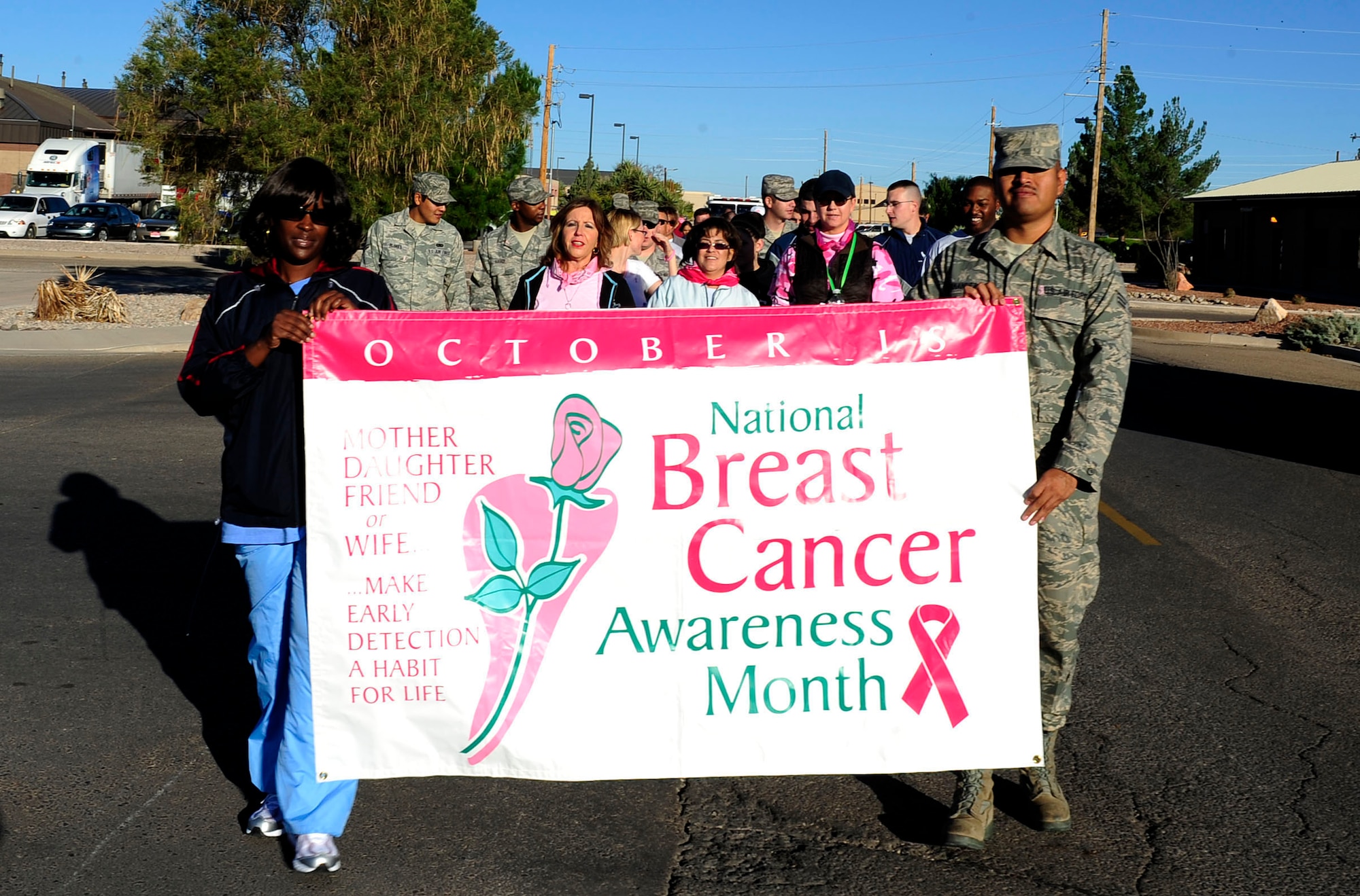 HOLLOMAN AIR FORCE BASE, N.M. -- Members of Team Holloman walk one mile in support of National Breast Cancer Awareness Month here, Oct. 15. The NBCAM organization is a partnership of national public service organizations, professional medical associations and government agencies working together to promote breast cancer awareness, share information on the disease and provide greater access to screening services. (U.S. Air Force photo by Senior Airman Tiffany Trojca)