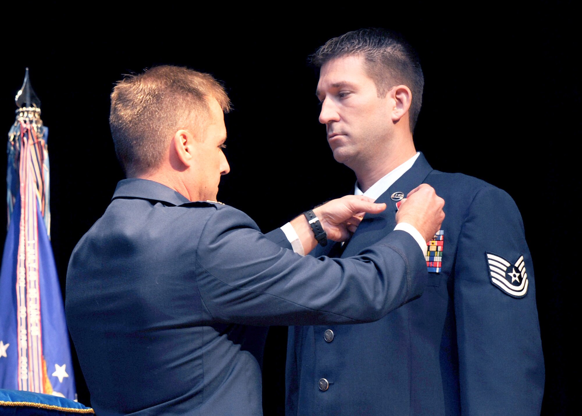 Tech. Sgt. Michael Williams is awarded the Bronze Star Medal with Valor by Col. John Wood Oct. 15, 2009 at Charleston Air Force Base, S.C. The Bronze Star is awarded to servicemembers for bravery, acts of merit or meritorious service and may be awarded with valor for courage under fire. Sergeant Williams is an explosive ordnance technician with the 437th Civil Engineer Squadron and Colonel Wood is the 437th Airlift Wing commander. (U.S. Air Force photo/Senior Airman Katie Gieratz)