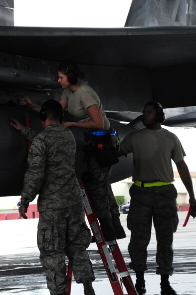 (L to R) Amn 1st Class Jeremy Cooper, Amn 1st Class Christee Drake, and Amn 1st Class Darrel Evans, all weapons load team members with the 44th Aircraft Maintenance Unit/18 Aircraft Maintenance Squadron conduct pre-flight maintenance checks on an F-15 eagle during the Ryukyu Air Warrior training event here at Kadena Air base, 15 October, 2009.The RAW is a weeklong training event that brought together aircraft from not only other PACAF bases, but other services as well
(U.S. Air Force photo/Staff Sgt. Lakisha A. Croley)

