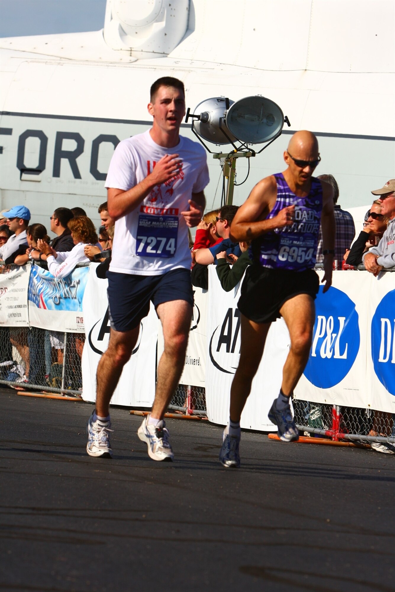 Master Sgt. Mike Sanders (right) and Second Lt. Evan McNichols (left) run for the finish line during the U.S. Air Force Half Marathon at Wright Patterson Air Force Base, Ohio, Sept. 19.  Sergeant Sanders ran the event one year and eight months after beating cancer.  Then-Cadet McNichols was one of Sergeant Sanders' students when he served as an instructor with the University of Portland's Air Force Reserve Officer Training Corps program. (Photo courtesy Master Sgt. Mike Sanders.)