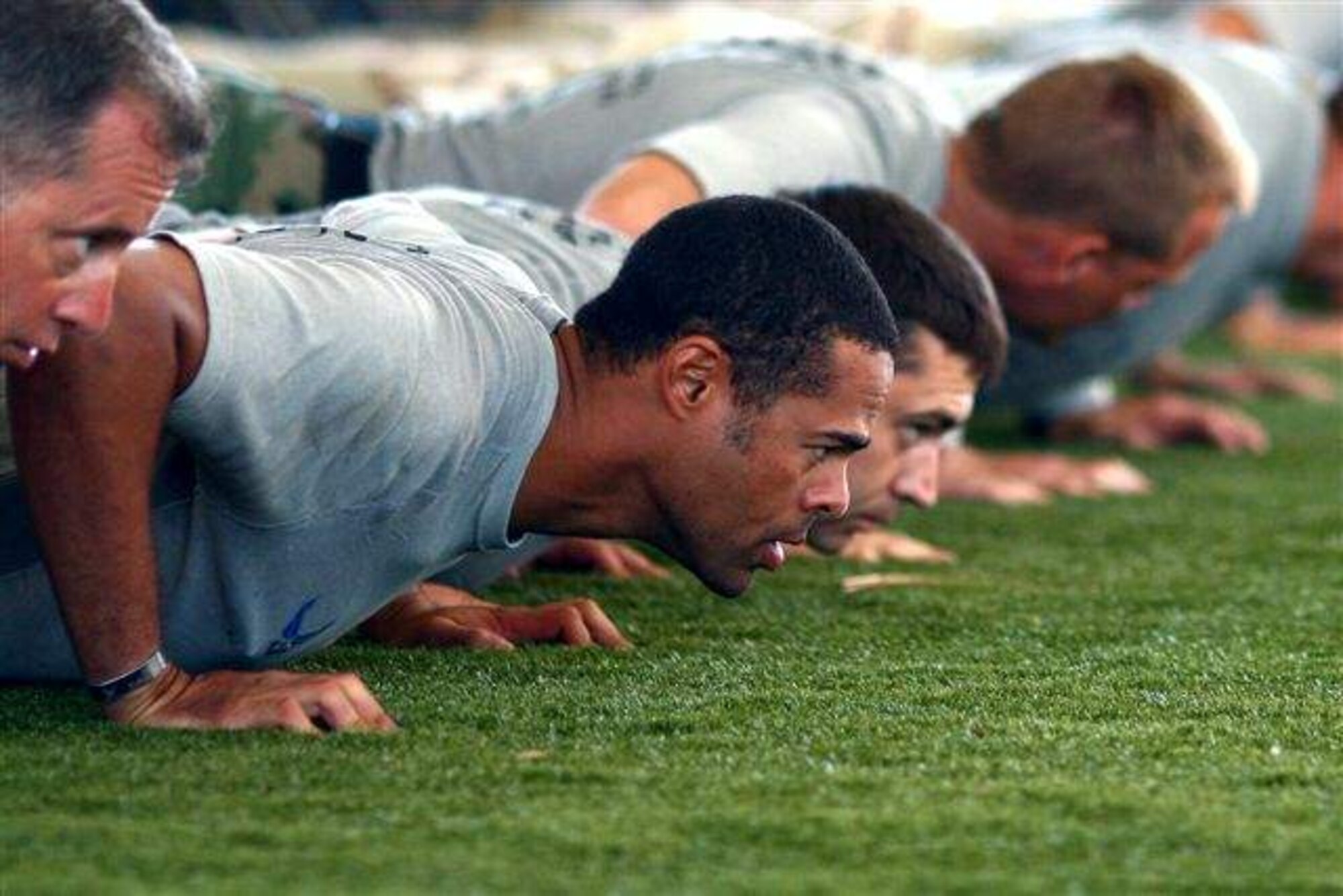 Special tactics Airmen perform push ups after completing the 824-mile memorial rucksack march Oct. 16, 2009, at Hurlburt Field, Fla. The men marched from Lackland Air Force Base, Texas, to Hurlburt Field to honor fallen special operations forces members. (U.S. Air Force photo/Drew Buchanan) 
