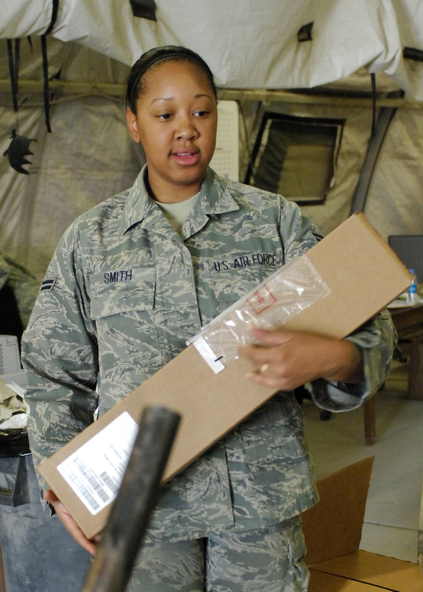 BAGRAM AIRFIELD, Afghanistan -- Airman First Class Ashley Smith, a supply Airman from the 455th Expeditionary Logistics Readiness Squadron, separates boxes so it will be easier for the customer to find their orders here, Oct. 19, 2009.  Airman Smith, a Hampton, Va., native, is deployed from Bolling Air Force Base, Wash., D.C.  (U.S. Air Force photo/Senior Airman Felicia Juenke)