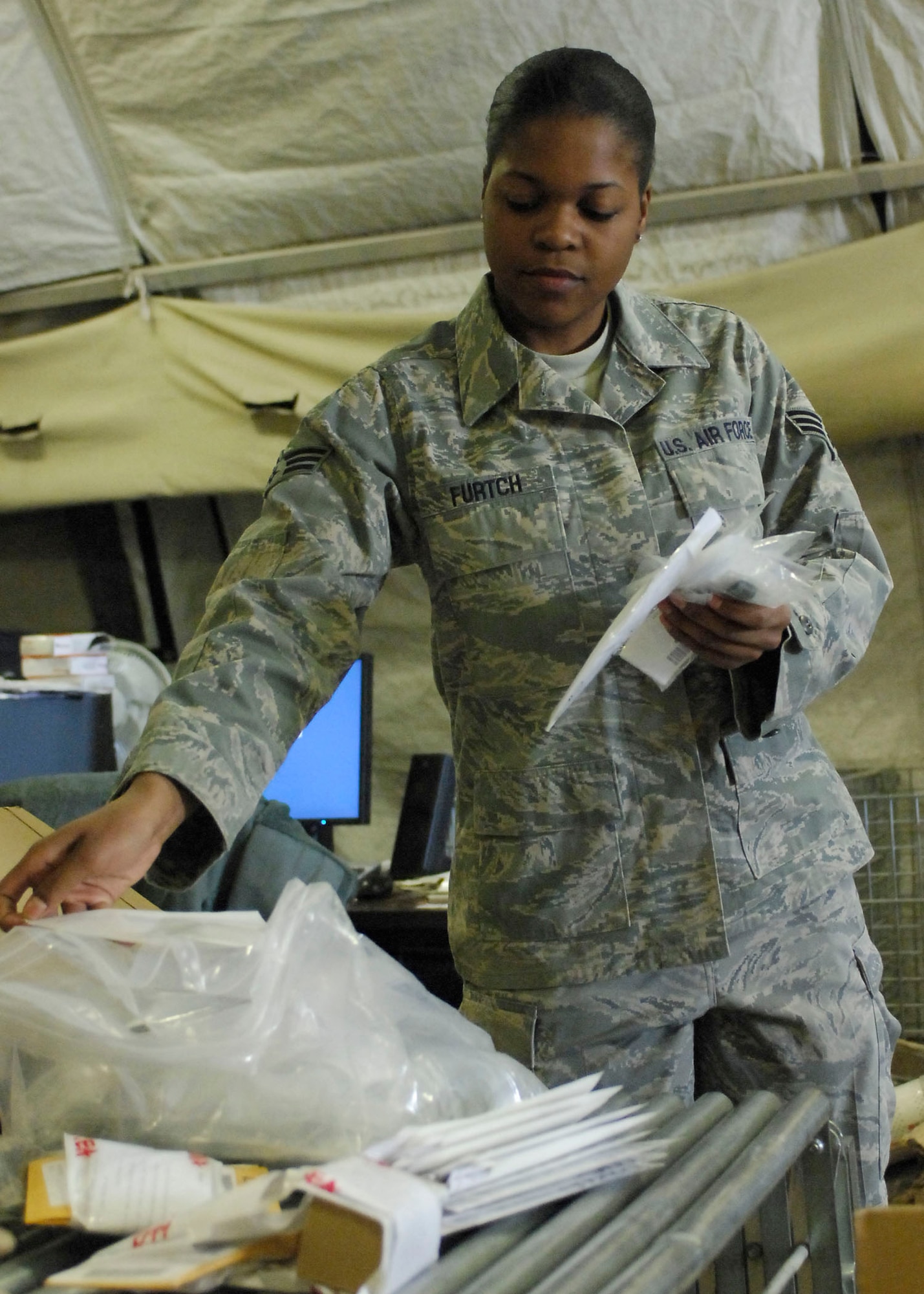 BAGRAM AIRFIELD, Afghanistan -- Senior Airman Ausha Furtch, a supply Airman from the 455th Expeditionary Logistics Readiness Squadron, gathers the equipment listed on the order sheet here, Oct. 19, 2009.  The 455th ELRS supply office receives new equipment and accounts for all the damaged equipment for the Air Force personnel at Bagram.  Airman Furtch is deployed from Robins Air Force Base, Ga., and hails from Oakland, Calif.  (U.S. Air Force photo/Senior Airman Felicia Juenke)