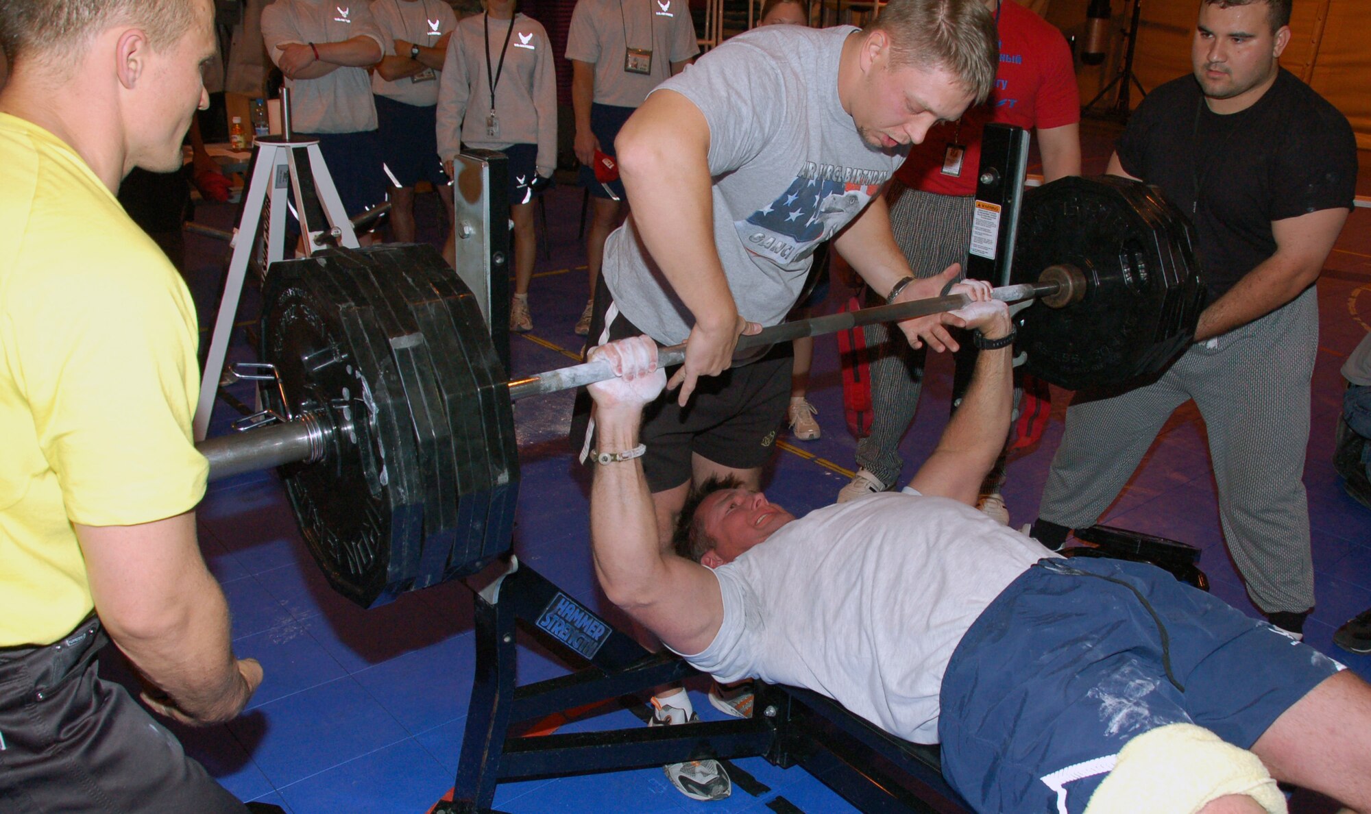 Master Sgt. Jason Byars, 421st Expeditionary Fighter Squadron, lifts 405 pounds of weight as Kyrgyz pro-athletes spot him during a friendly bench-press competition between Airmen at the Transit Center at Manas and Kyrgyz athletes Oct. 18, 2009. The weightlifting competition is the first of the events that the Airmen and the U.S. State Department officials in Kyrgyzstan in conjunction with the Kyrgyz Ministry of Sports are putting together to foster more relationships between the two nations. Sergeant Byars, superintendent with the 421st EFS, is deployed from Hill Air Force Base, Utah.  (U.S. Air Force photo/Staff Sgt. Olufemi Owolabi)   