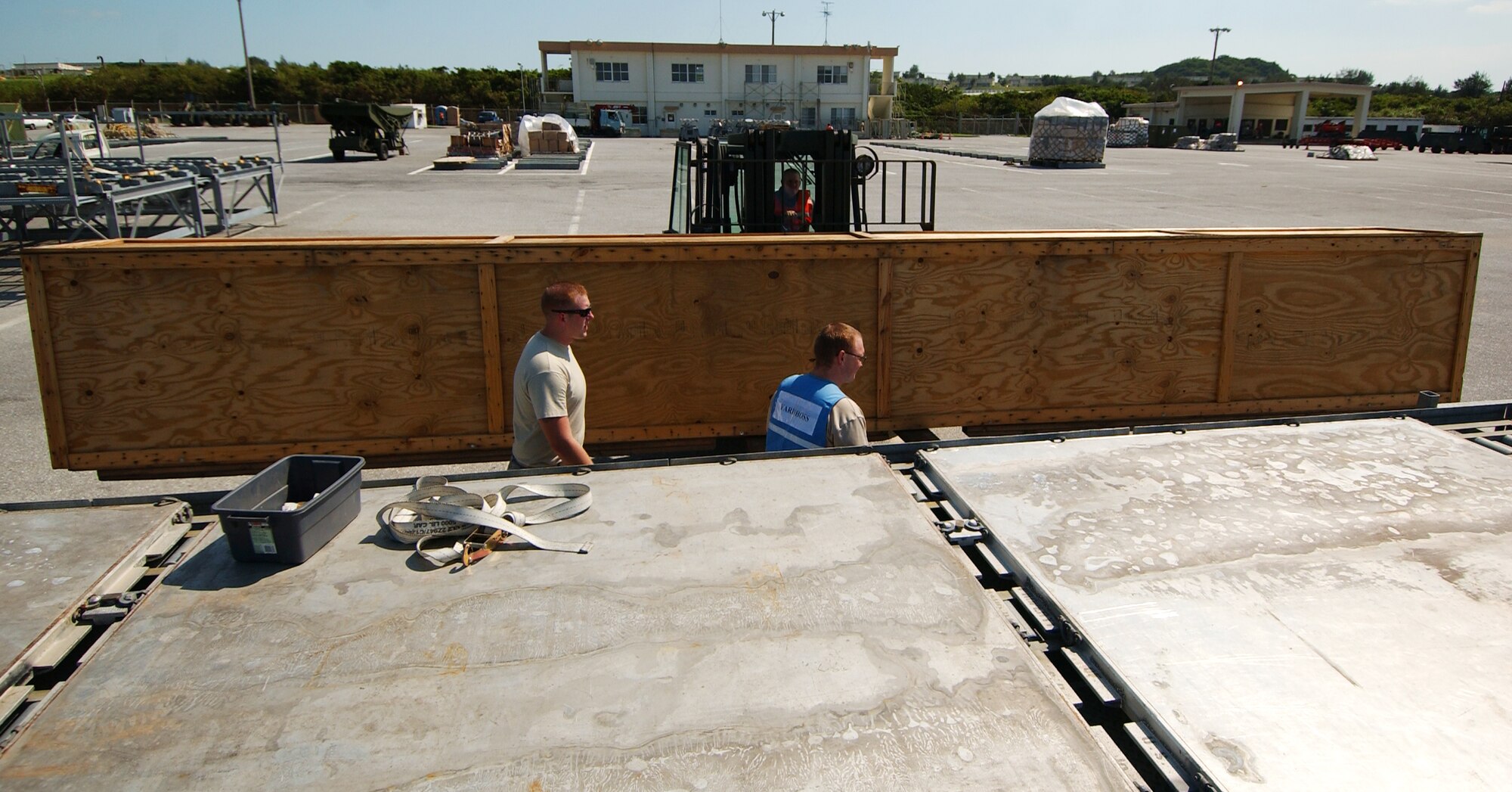 Staff Sgt. John Martz and Senior Airman Todd Graham, both from 18th Logistics Readiness Squadron, finish assembling the palettes on a multi-palette train to place a boom assembly for cargo shipping at Kadena Air Base, Japan Oct. 19 during Exercise Beverly High 10-01. The 18th Wing is participating in a Local Operational Readiness Exercise to test the readiness of Kadena Airmen Oct. 19-23. 
(U.S. Air Force photo/Tech. Sgt. Rey Ramon)           