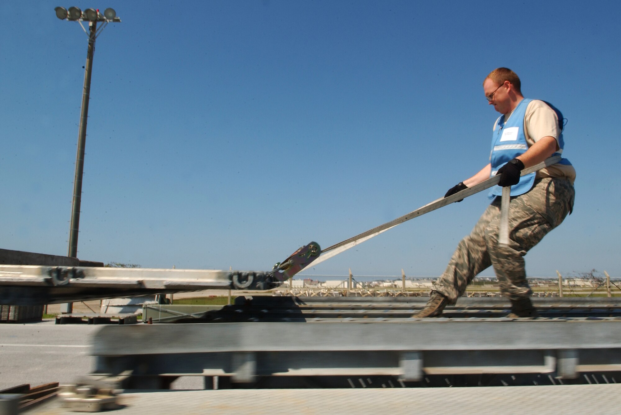 Staff Sgt. John Martz, 18th Logistics Readiness Squadron chief yard boss, drags palettes onto a multi-palette train to place a boom assembly for cargo shipping at Kadena Air Base, Japan Oct. 19 during Exercise Beverly High 10-01. The 18th Wing is participating in a Local Operational Readiness Exercise to test
the readiness of Kadena Airmen Oct. 19-23.  
(U.S. Air Force photo/Tech. Sgt. Rey Ramon)              