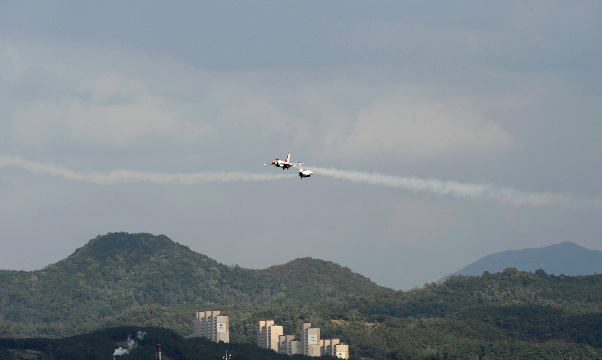 Two U.S. Air Force Thunderbird F-16s fly over Osan Air Base, Republic of Korea, upon arrival Oct. 19. The Thunderbirds will be performing as part of Air Power Day here Oct. 21. (U.S. Air Force photo/Staff Sgt. Brian Ferguson)