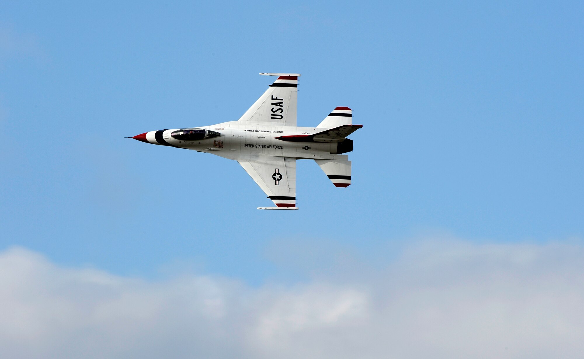 A U.S. Air Force Thunderbird F-16 flies over Osan Air Base, Republic of Korea, upon arrival Oct. 19. The Thunderbirds will be performing as part of Air Power Day here Oct. 21. (U.S. Air Force photo/Staff Sgt. Brian Ferguson)