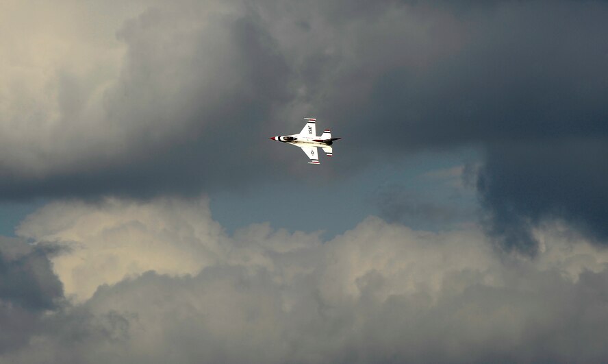 A U.S. Air Force Thunderbird F-16 flies over Osan Air Base, Republic of Korea, upon arrival Oct. 19. The Thunderbirds will be performing as part of Air Power Day here Oct. 21. (U.S. Air Force photo/Staff Sgt. Brian Ferguson)
