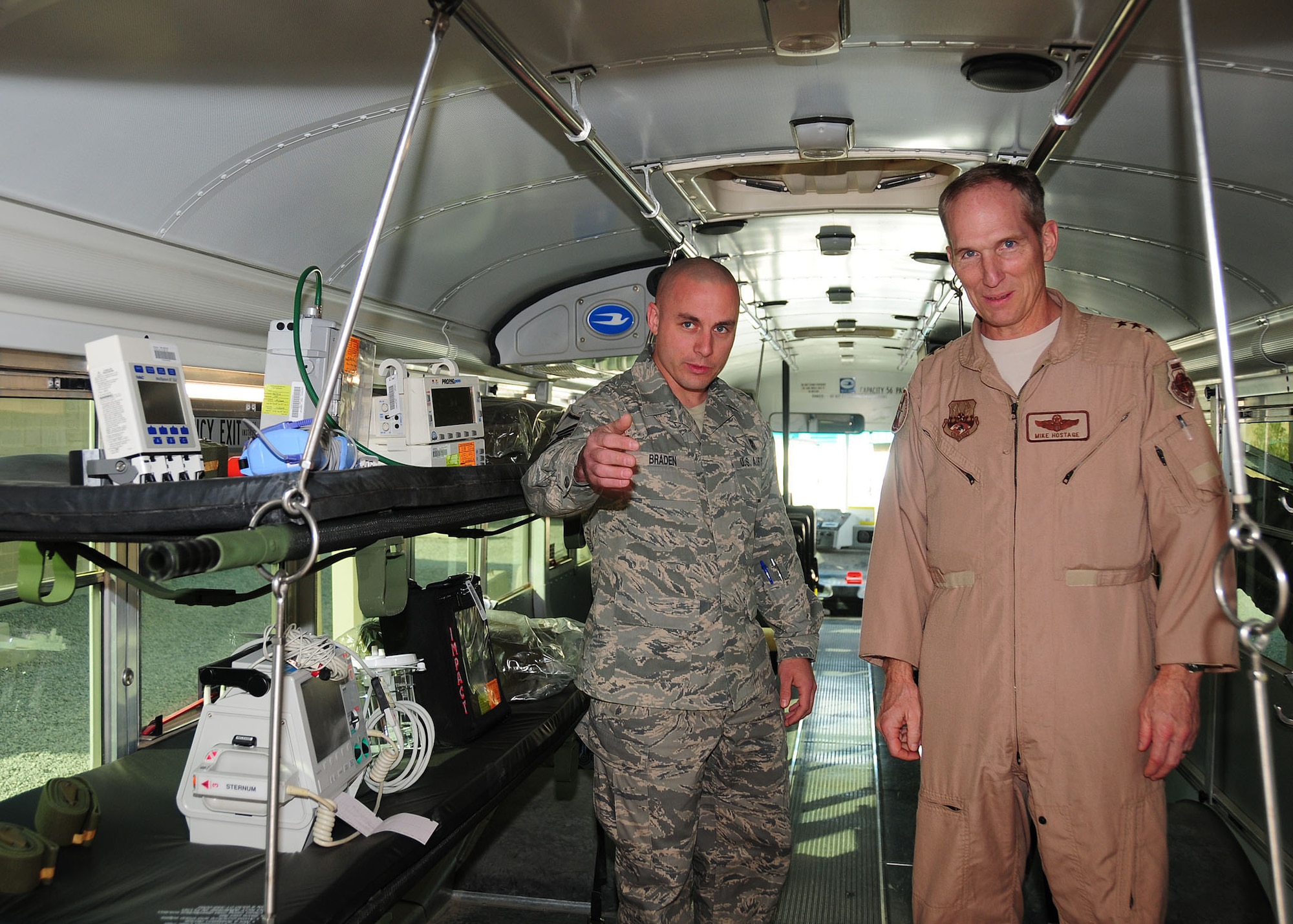SOUTHWEST ASIA -- Lt. Gen. Mike Hostage, Commander, U.S. Air Forces Central Command, receives a briefing from Master Sgt. Alan Braden, 386th Medical Group Contingency Aeromedical Staging Facility non-commissioned officer in charge, on the ambulance bus during a visit to the 386th Air Expeditionary Wing at an undisclosed location in Southwest Asia Oct. 18, 2009.  Sergeant Braden is deployed from the 88th Medical Operations Squadron, Wright-Patterson Air Force Base, Ohio and hails from Beavercreek, Ohio.  (U.S. Air Force photo/Tech. Sgt. Tony Tolley)
