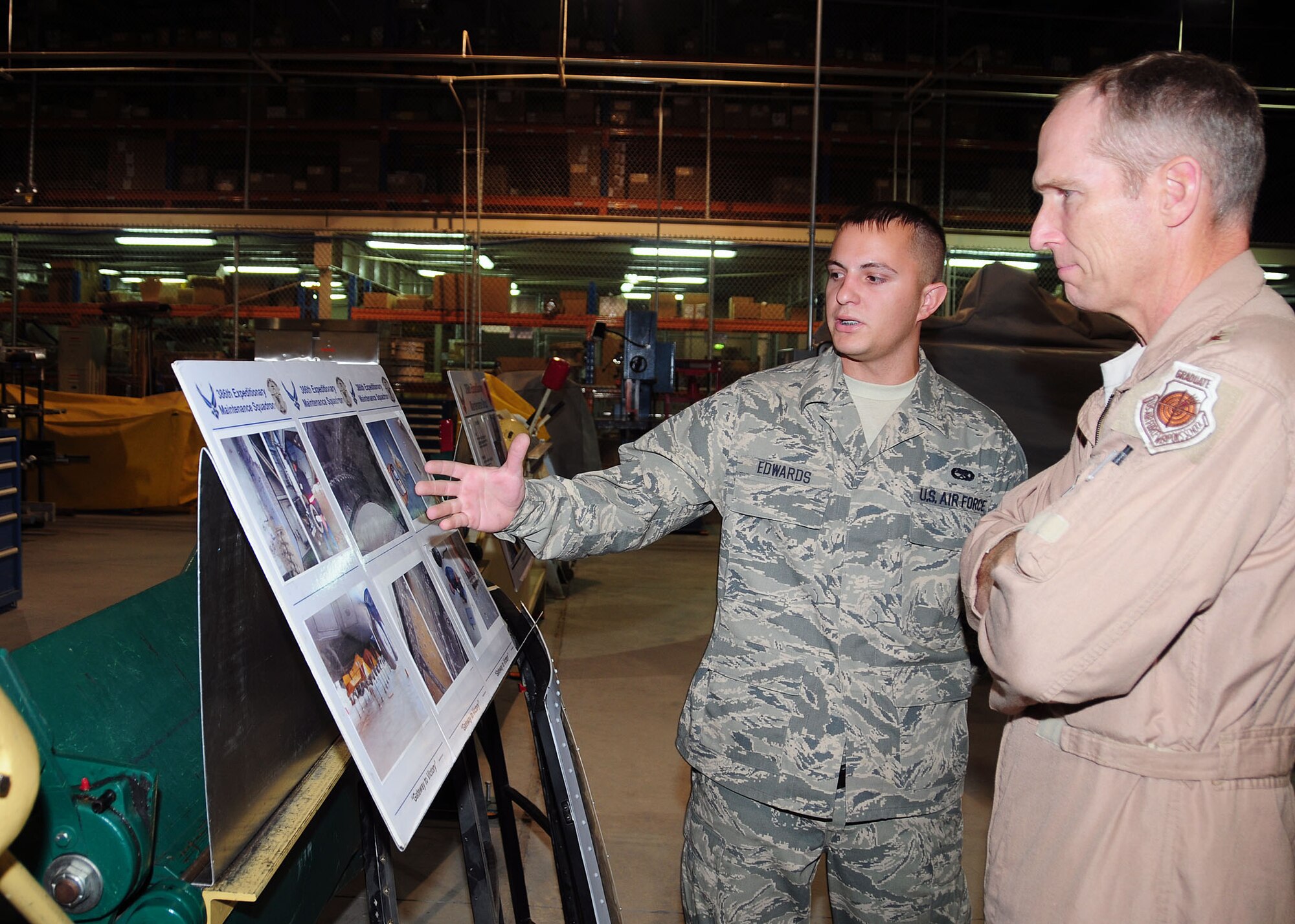SOUTHWEST ASIA -- Lt. Gen. Mike Hostage, Commander, U.S. Air Forces Central Command, is briefed by Senior Airman Steven Edwards, 386th Expeditionary Maintenance Squadron metals technician journeyman, on the combat metals shop during a visit to the 386th Air Expeditionary Wing at an undisclosed location in Southwest Asia Oct. 18, 2009.  Airman Edwards is deployed from the 509th Maintenance Squadron, Whiteman Air Force Base, Mo., and hails from Charleston, S.C.  (U.S. Air Force photo/Tech. Sgt. Tony Tolley)