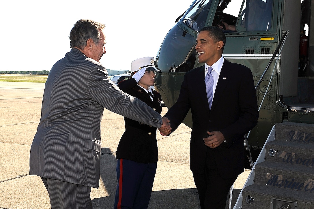 Former President George H.W. Bush, left, greets President Barack Obama ...