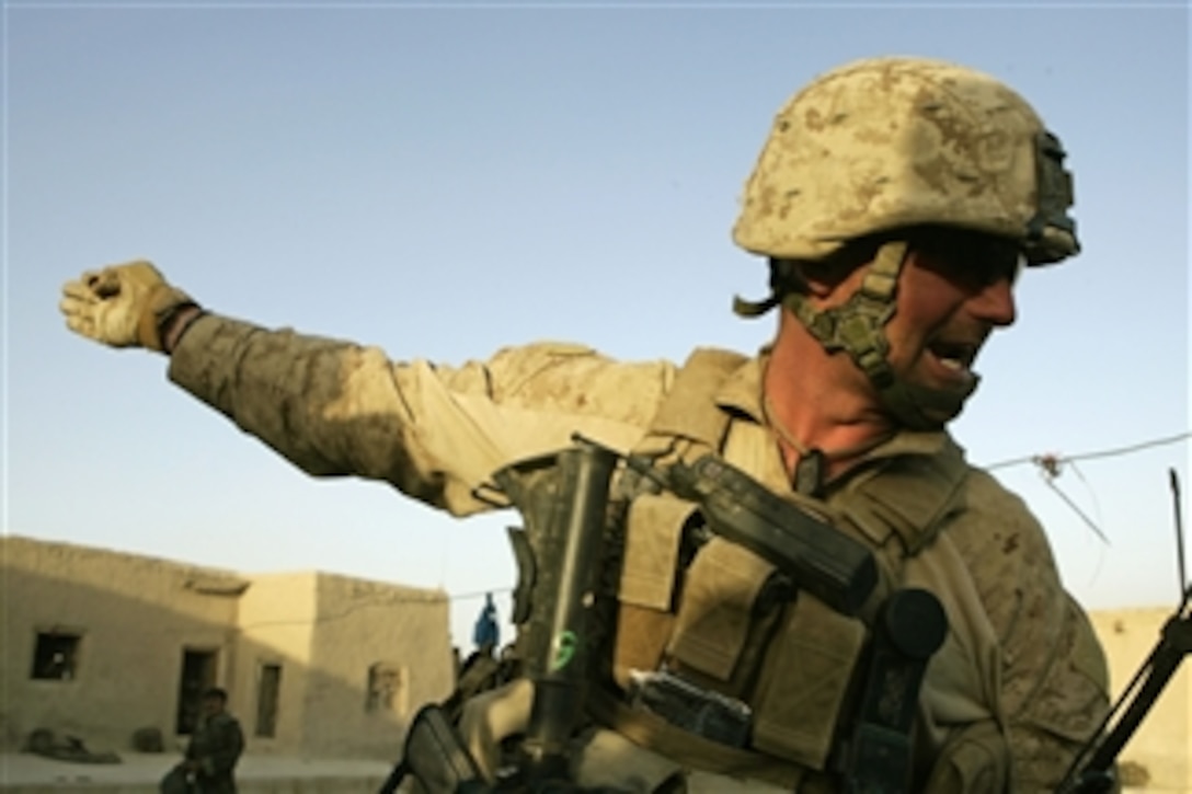 U.S. Marine Corps Sgt. Deacon Holten, a squad leader with 2nd Battalion, 8th Marine Regiment, directs fellow Marines during an attack at Patrol Base Bracha in the Garmsir district of Helmand province, Afghanistan, on Oct. 9, 2009.  The Marines are deployed with Regimental Combat Team 3, whose mission is to conduct counterinsurgency operations in partnership with Afghan security forces in southern Afghanistan.  