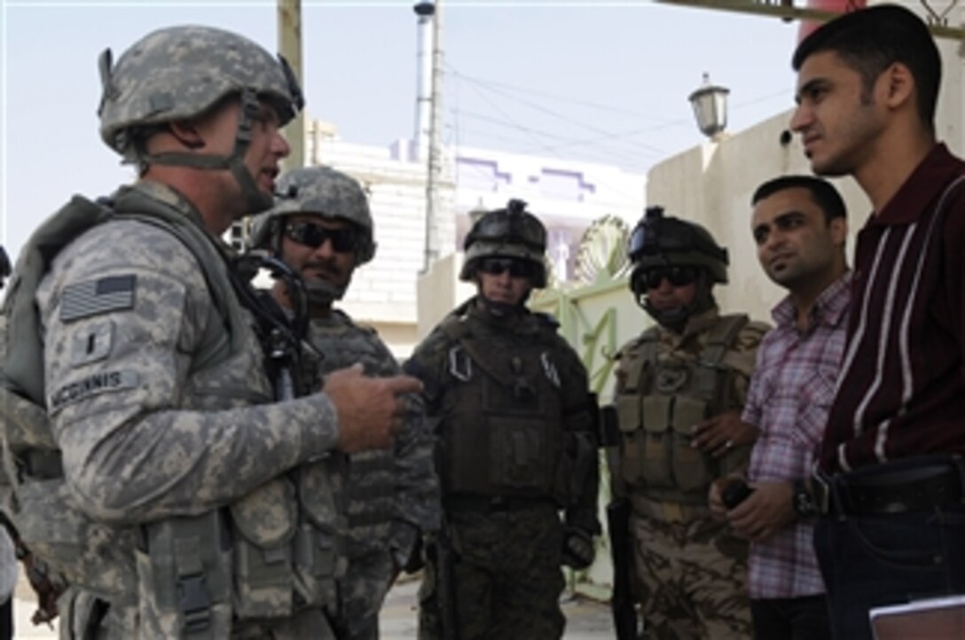 U.S. Army 1st Lt. Christian McGinnis, assigned to the 1314th Civil Affairs Company, 17th Fires Brigade, and Iraqi soldiers speak with residents during a joint patrol in Najibiyah, near Basra, Iraq, on Sept. 29, 2009.  The patrol is gathering information about the area and nearby bridge traffic.  