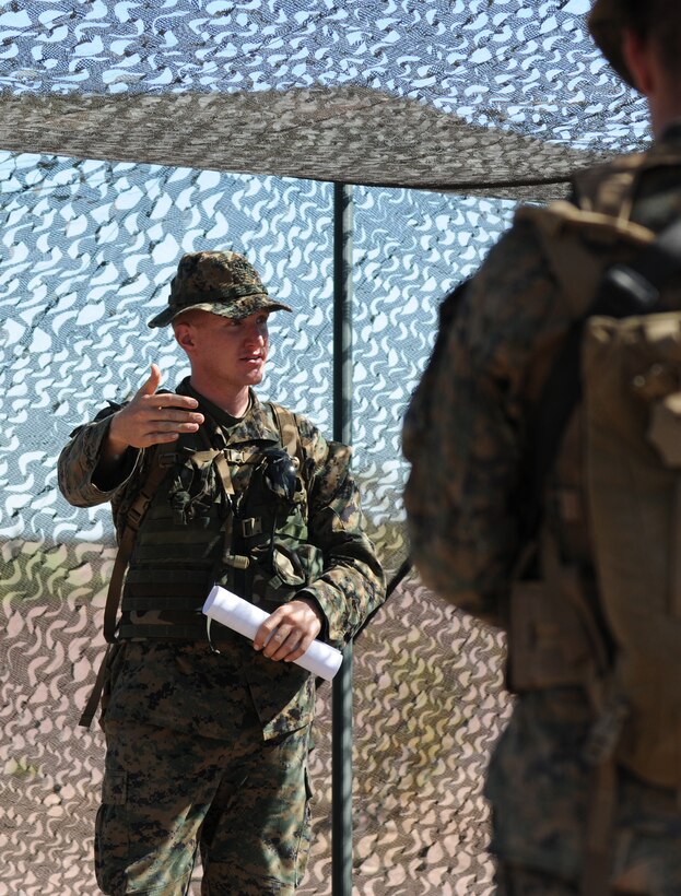 2nd Lt. Daniel Kapcuik, assistant operations officer with Headquarters and Service Company, 1st Battalion, 2nd Marine Regiment, briefs his Marines before infantry tactics training at Graze Range at the U.S. Army Yuma Proving Ground in Arizona, Oct. 18, 2009. Comprised of Marines with noninfantry specialties, the Camp Lejeune, N.C.-based company is preparing to operate as an infantry company during their upcoming deployment to Afghanistan in the spring of 2010.