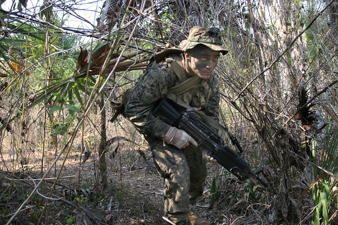 Pfc. Richard Dauler, a Marine with Company E, Battalion Landing Team 2/4, 11th Marine Expeditionary Unit, conducts a patrol during an exercise here Oct. 19. The MEU members learned jungle patrolling techniques from Australian soldiers attached to the International Stabilization Force (ISF). The Marines trained with members of the Timor Leste Defense Force and the Australian Army during an exercise focused on promoting theater cooperation through civic action projects and military interaction