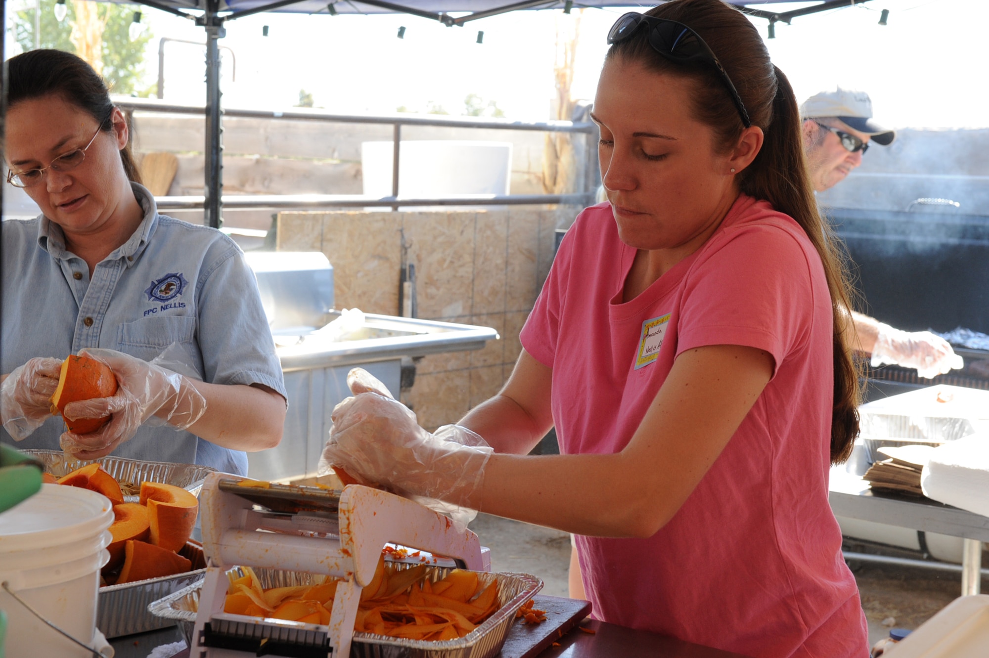LAS VEGAS, Nev.--Tech. Sgt. Amanda White, 57th Advisory Tactical Support Squadron air crew flight equipment noncommissioned offiecer in charge, slices a pumpkin for pumpkin chips at the Fall Pumpkin Patch at The Farm, Oct. 17, 2009. Several Nellis Air Force Base Airmen have volunteered at The Farm to help the farm owners maintain activities like the Fall Pumpkin Patch and eventually expand the area where The Farm is located.
(U.S. Air Force Photo by Airman 1st Class Jamie Nicley)