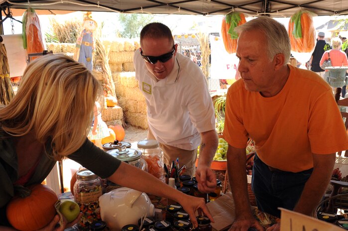 LAS VEGAS, Nev.--Staff Sgt. Bradley Steffens, 99th Logistics Readiness Squadron equipment account office craftsman, and farm owner Glenn Linsenbardt sell pumpkins and other farm items at the Fall Pumpkin Patch at The Farm, Oct. 17, 2009. Several Nellis Air Force Base Airmen volunteered at The Farm to help the farm owners maintain activities like the Fall Pumpkin Patch and eventually expand the area where The Farm is located.
(U.S. Air Force Photo by Airman 1st Class Jamie Nicley)