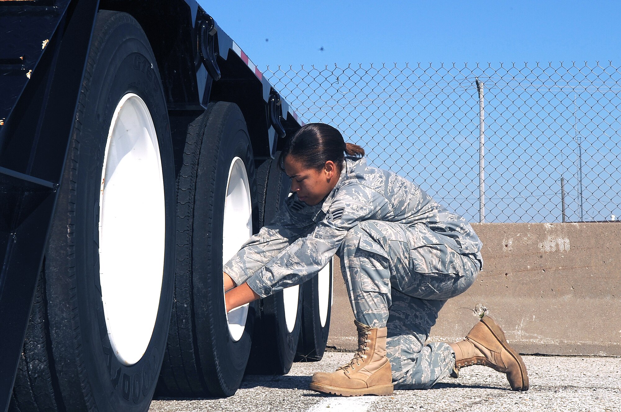 WHITEMAN AIR FORCE BASE, Mo. -- Senior Airman Kristin Campbell, 509th Logistics Readiness Squadron vehicle operator, verifies each tire on her "low boy" trailer is inflated to the correct level.  Operators must inspect their equipment before each driving assignment.
(U.S. Air Force Photo/Airman 1st Class Torey Griffith)