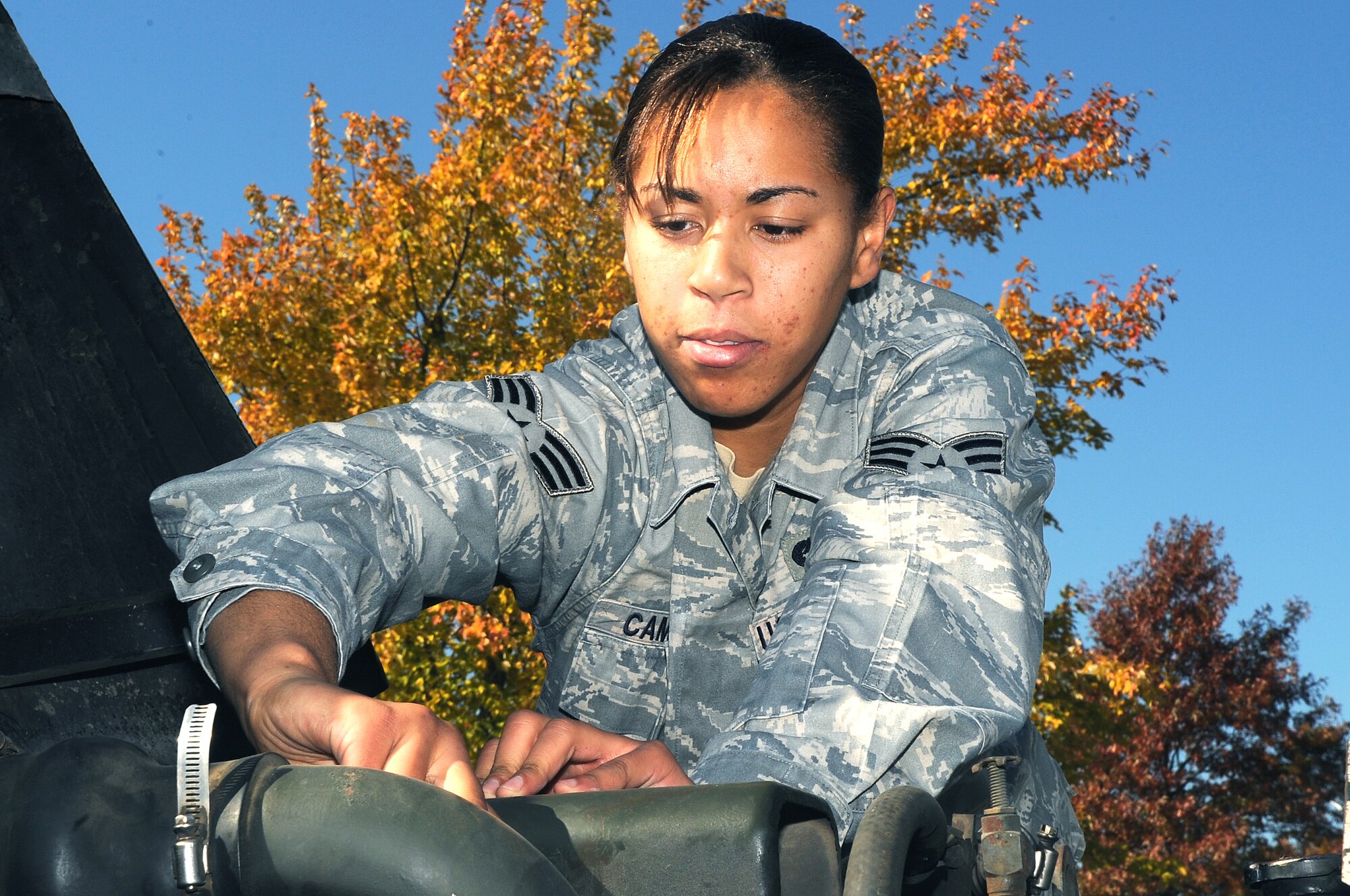 WHITEMAN AIR FORCE BASE, Mo. -- Senior Airman Kristin Campbell, 509th LRS Vehicle Operator, performs a visual inspection under the hood of a "deuce and a half," two and a half ton truck.  Operators must inspect their vehicles before each driving assignment.
(U.S. Air Force photo / A1C Torey Griffith)